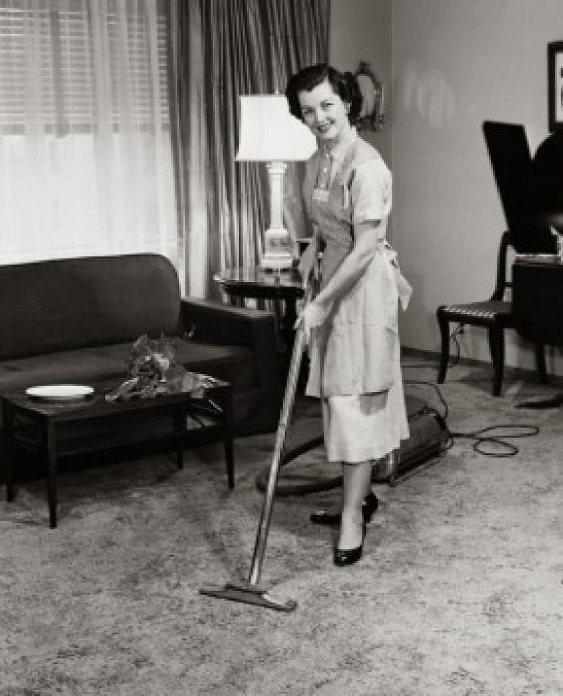 Portrait of a young woman cleaning the carpet with a vacuum cleaner Canvas Art - (18 x 24)