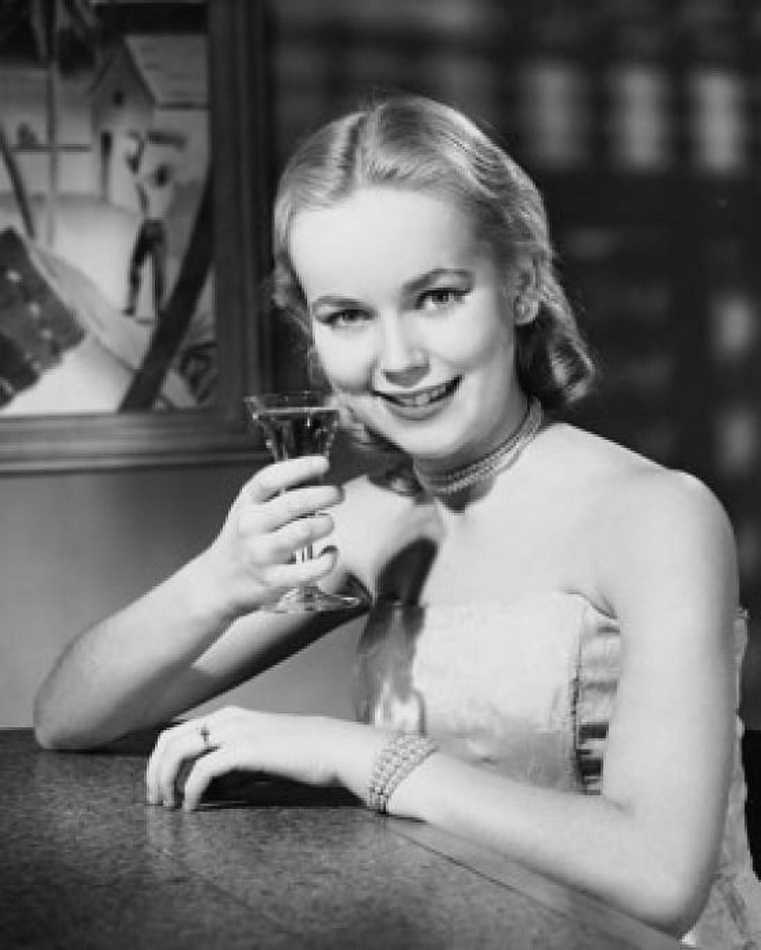 Portrait of a young woman drinking a martini Canvas Art - (18 x 24)