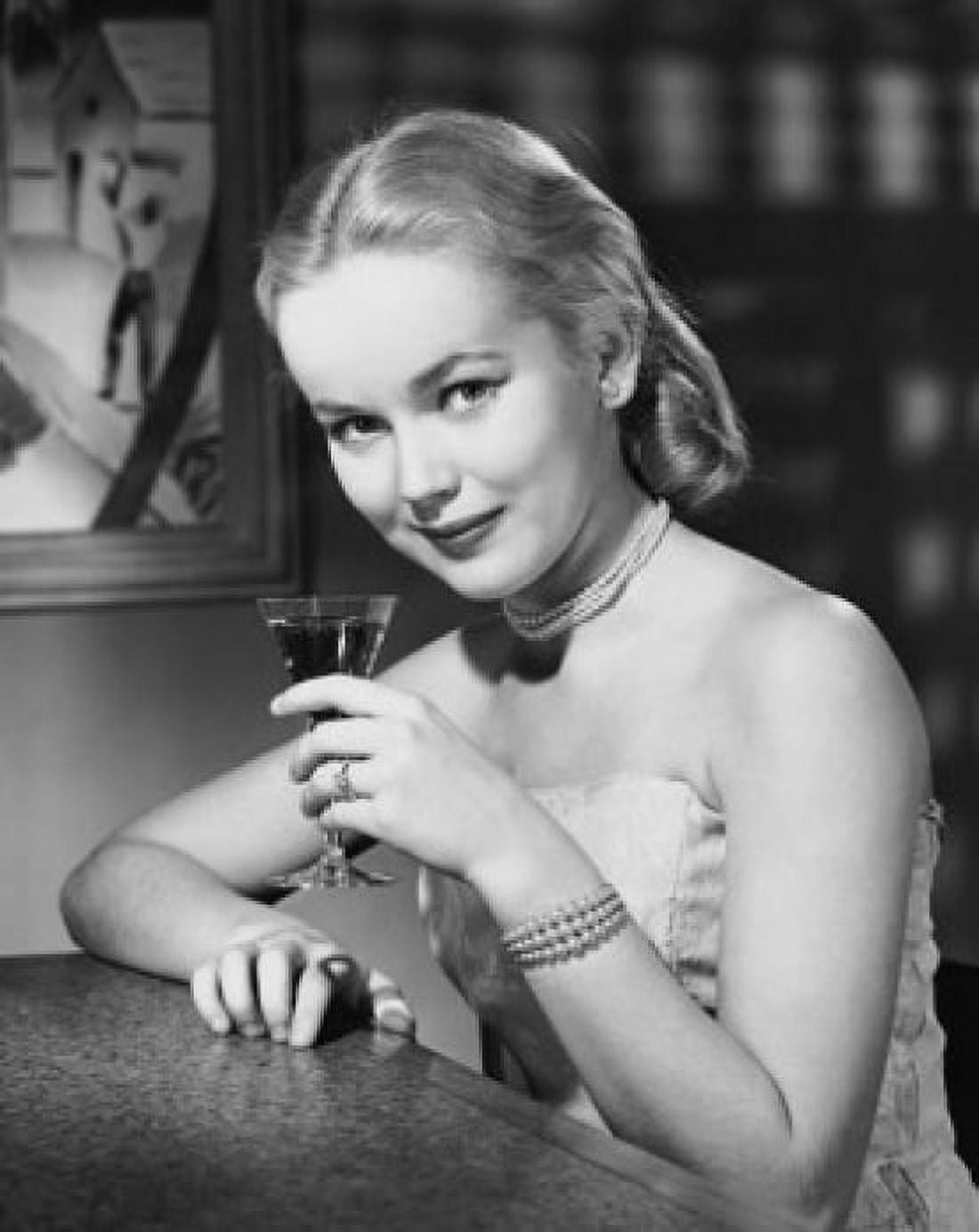 Portrait of a young woman drinking a martini Canvas Art - (24 x 36)