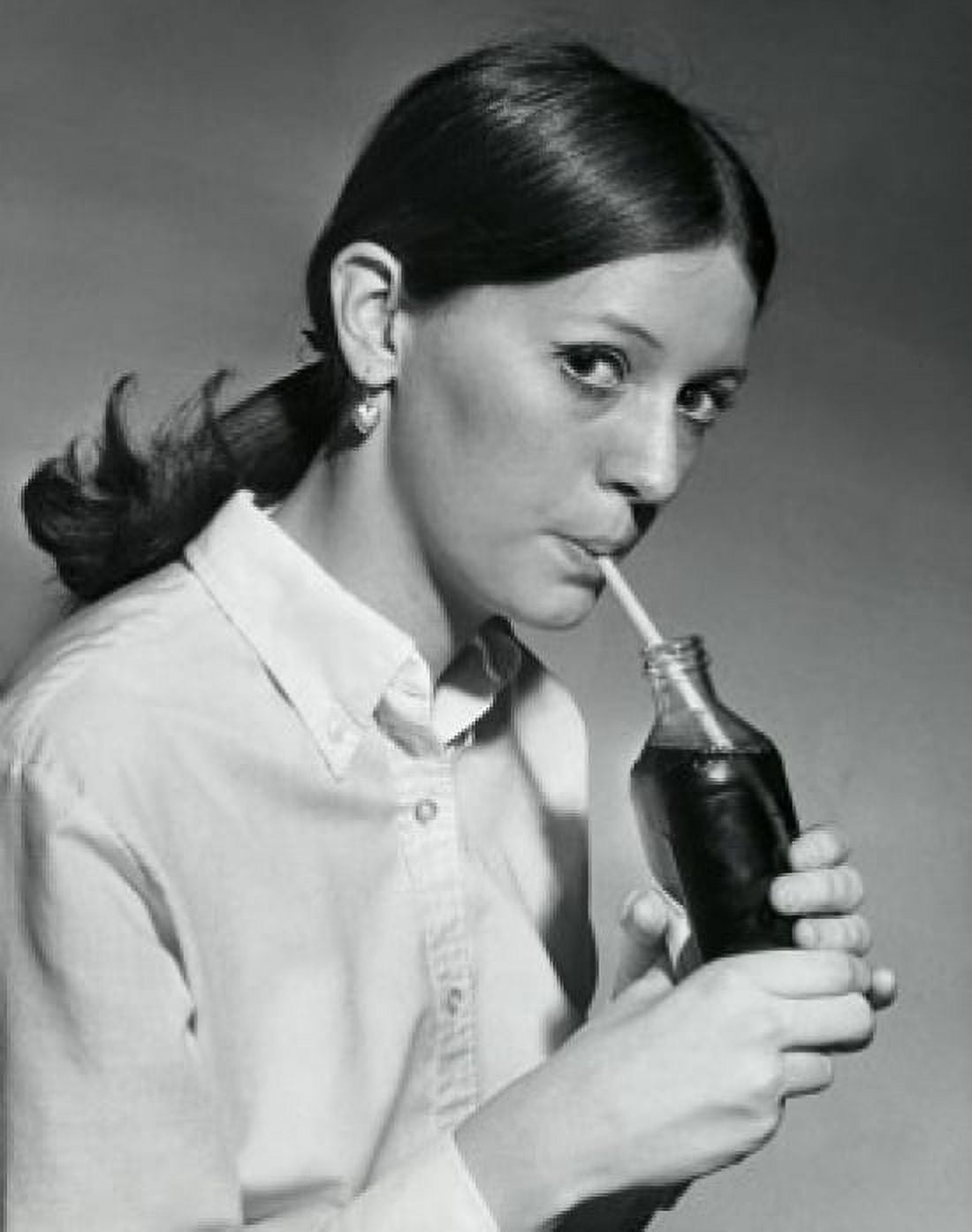 Portrait of a young woman drinking out of a bottle with a drinking straw Canvas Art - (18 x 24)