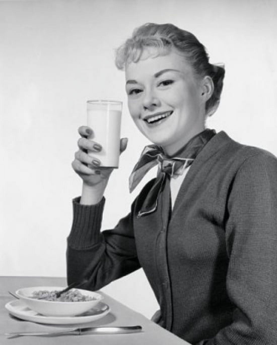 Portrait of a young woman eating breakfast Canvas Art - (18 x 24)