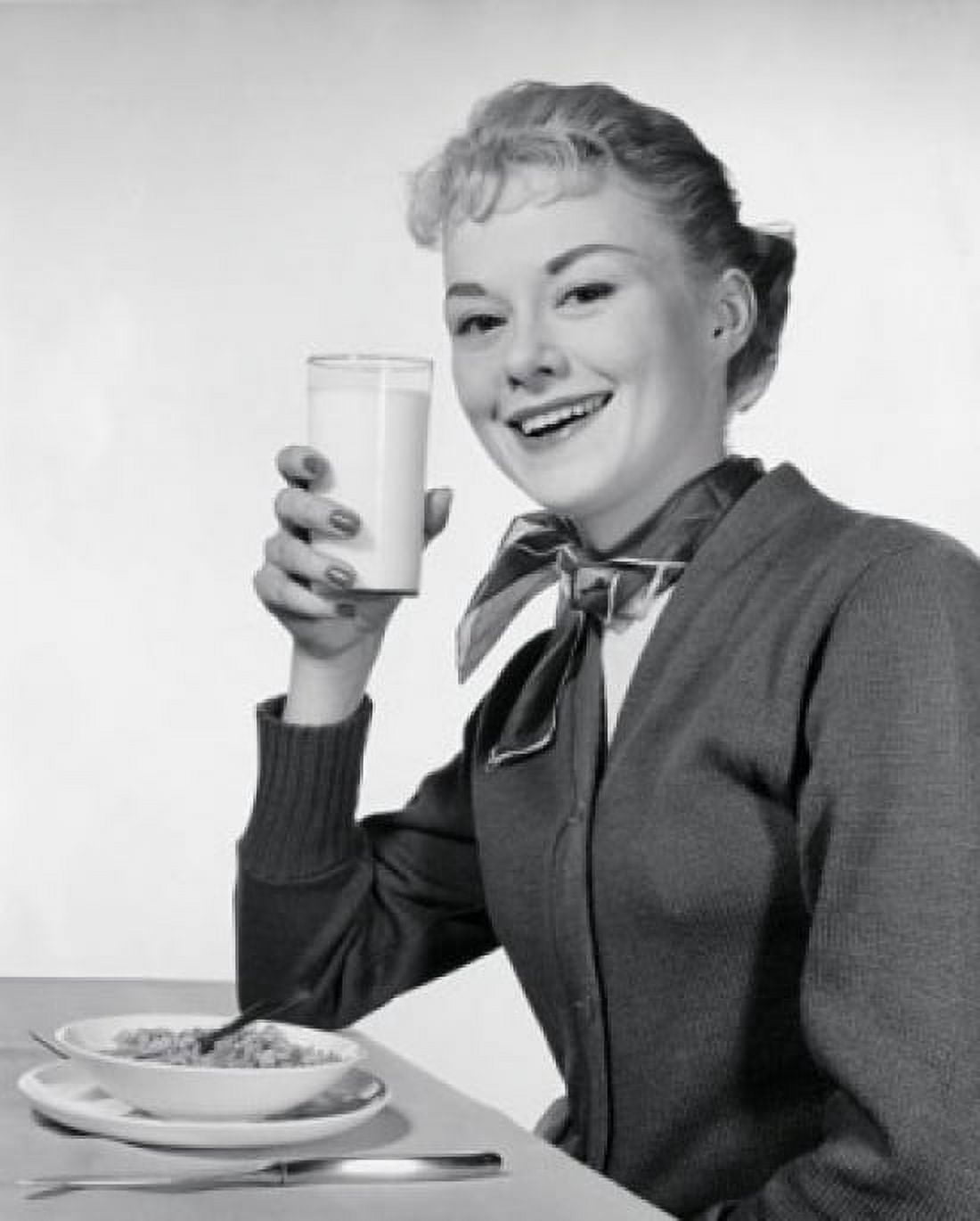 Portrait of a young woman eating breakfast Canvas Art - (24 x 36)