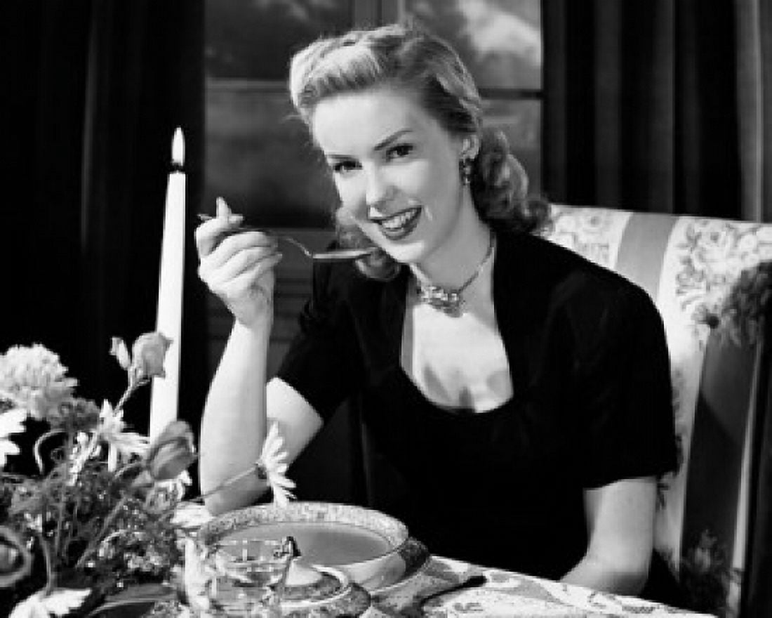 Portrait of a young woman eating soup by candlelight Canvas Art - (18 x 24)