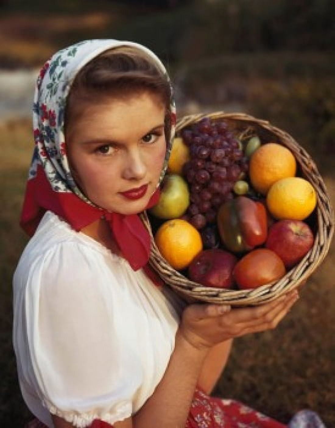 Portrait of a young woman holding a basket of fruit Canvas Art - (18 x 24)