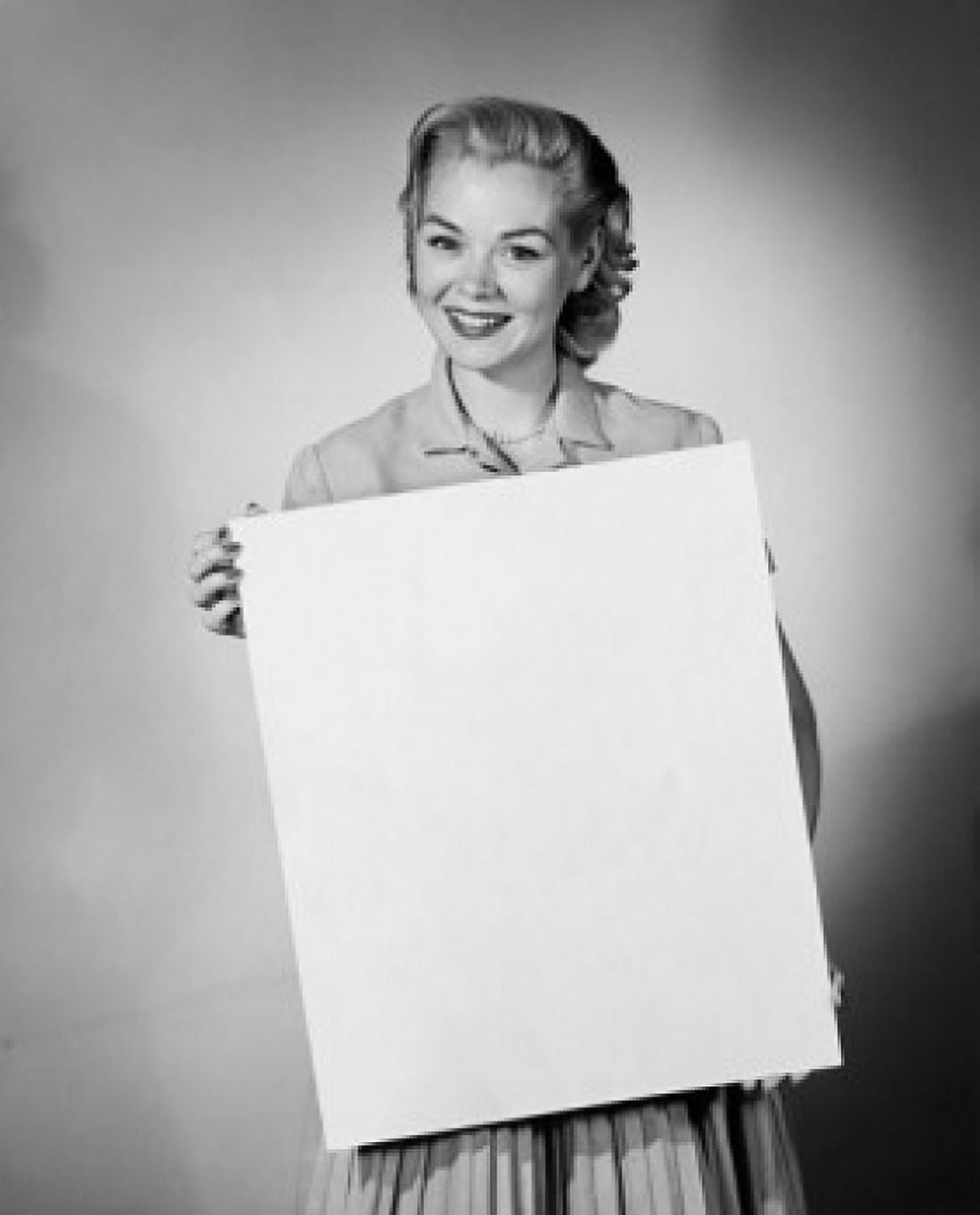 Portrait of a young woman holding a blank placard Canvas Art - (18 x 24)