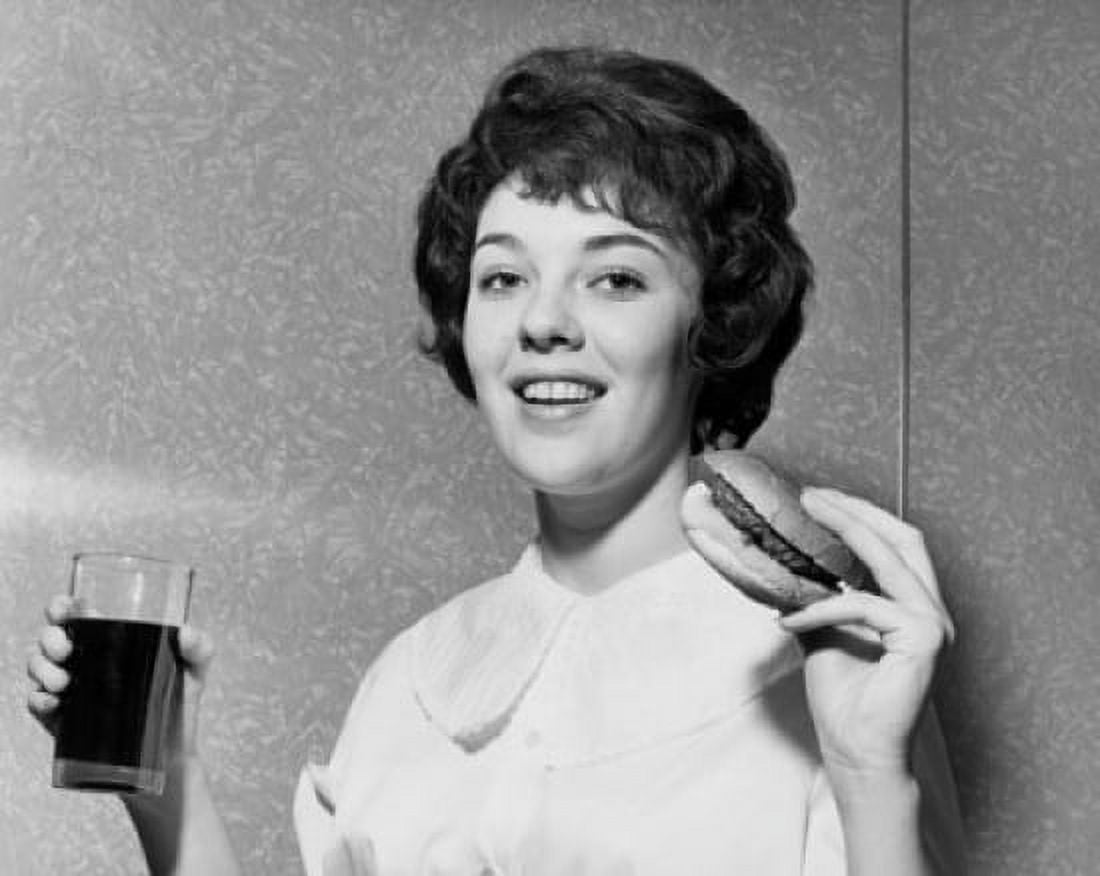 Portrait of a young woman holding a hamburger and a drink Canvas Art - (24 x 36)
