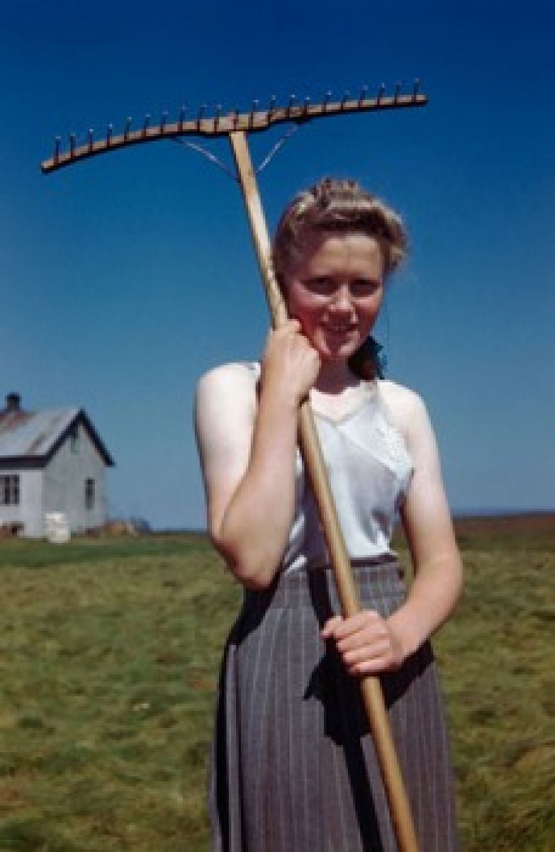Portrait of a young woman holding a rake Canvas Art - (18 x 24)