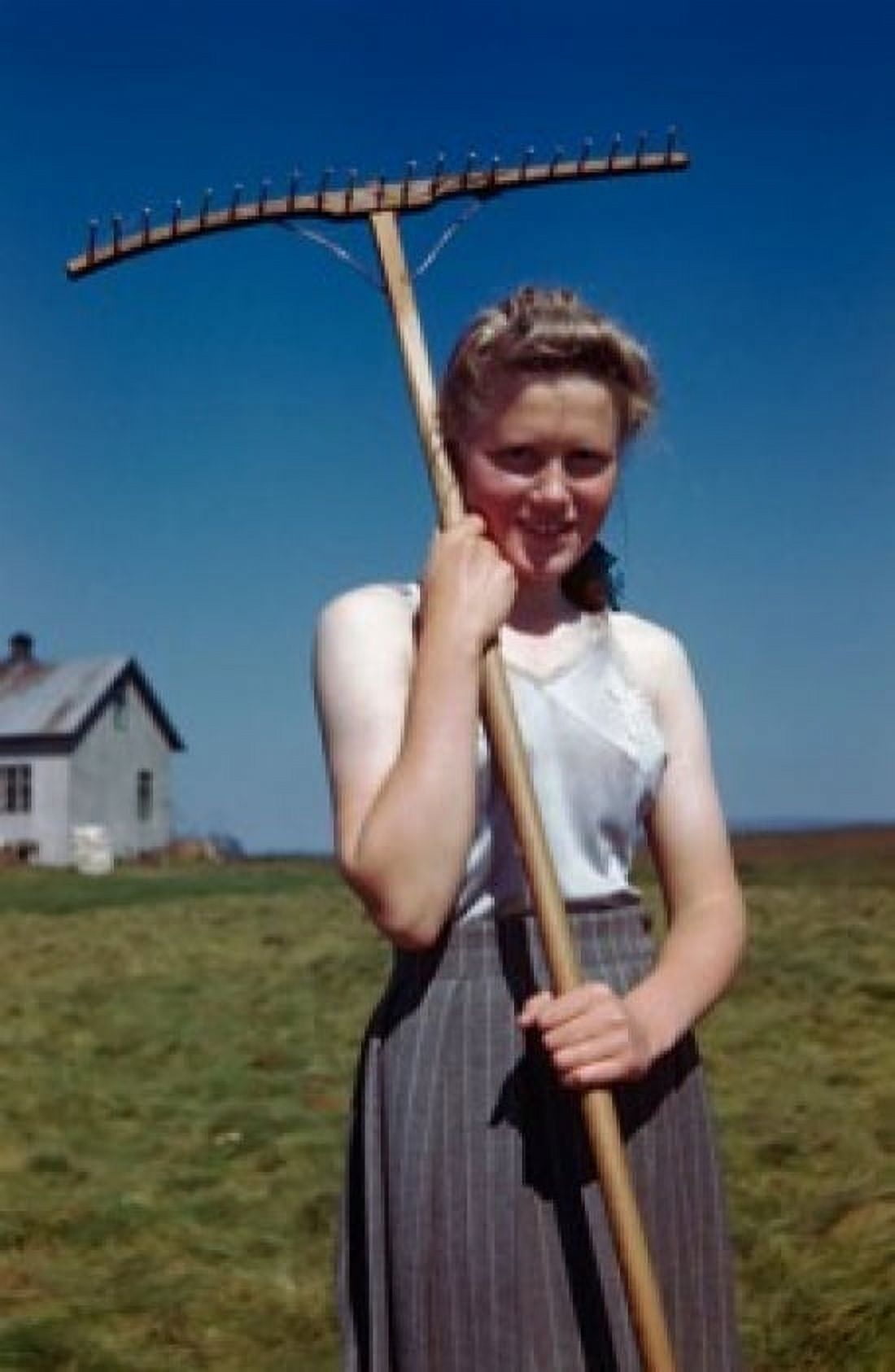 Portrait of a young woman holding a rake Canvas Art - (24 x 36)