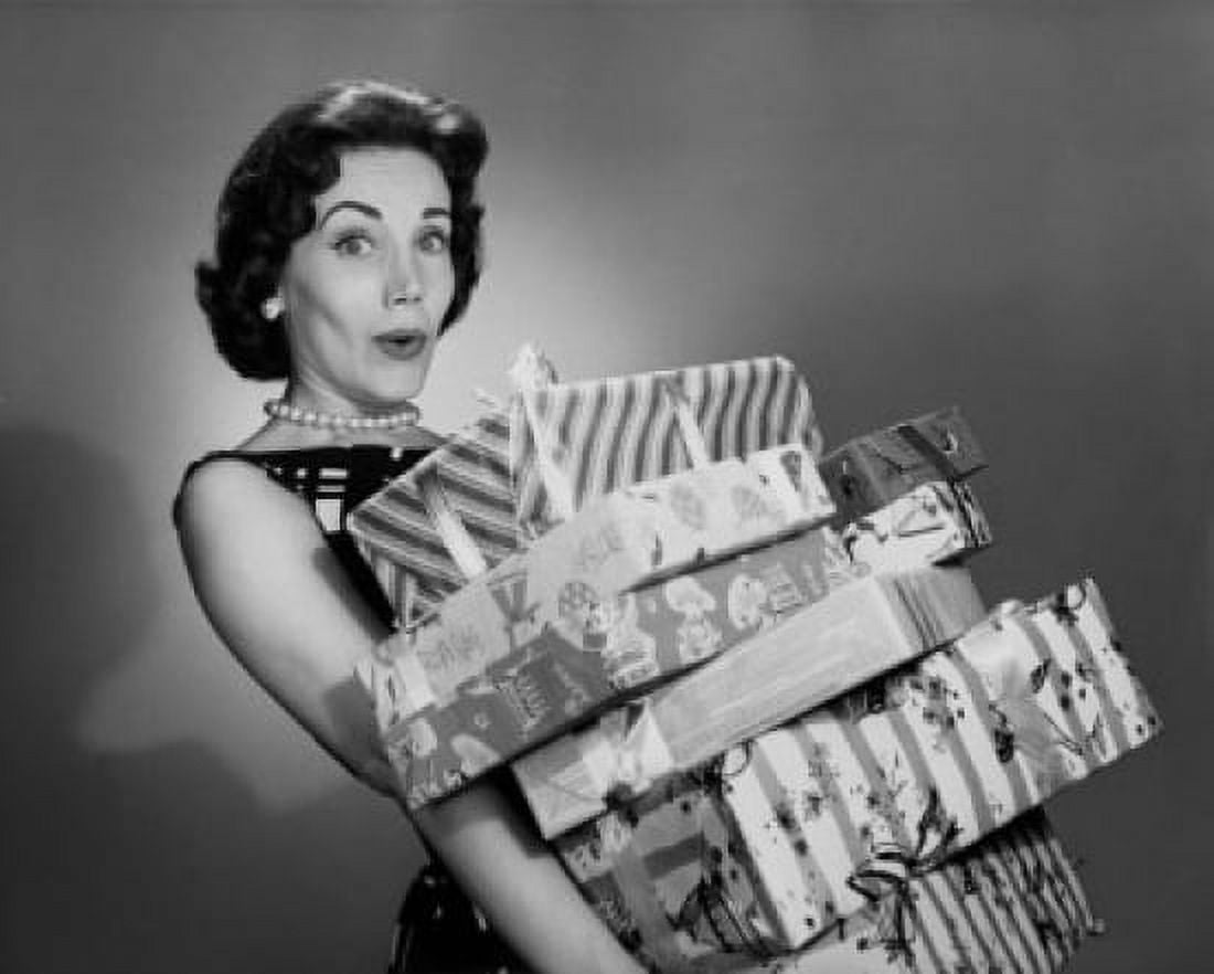Portrait of a young woman holding a stack of Christmas present Canvas Art - (18 x 24)