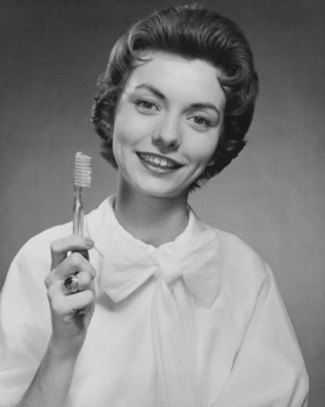 Portrait of a young woman holding a toothbrush Canvas Art - (18 x 24)