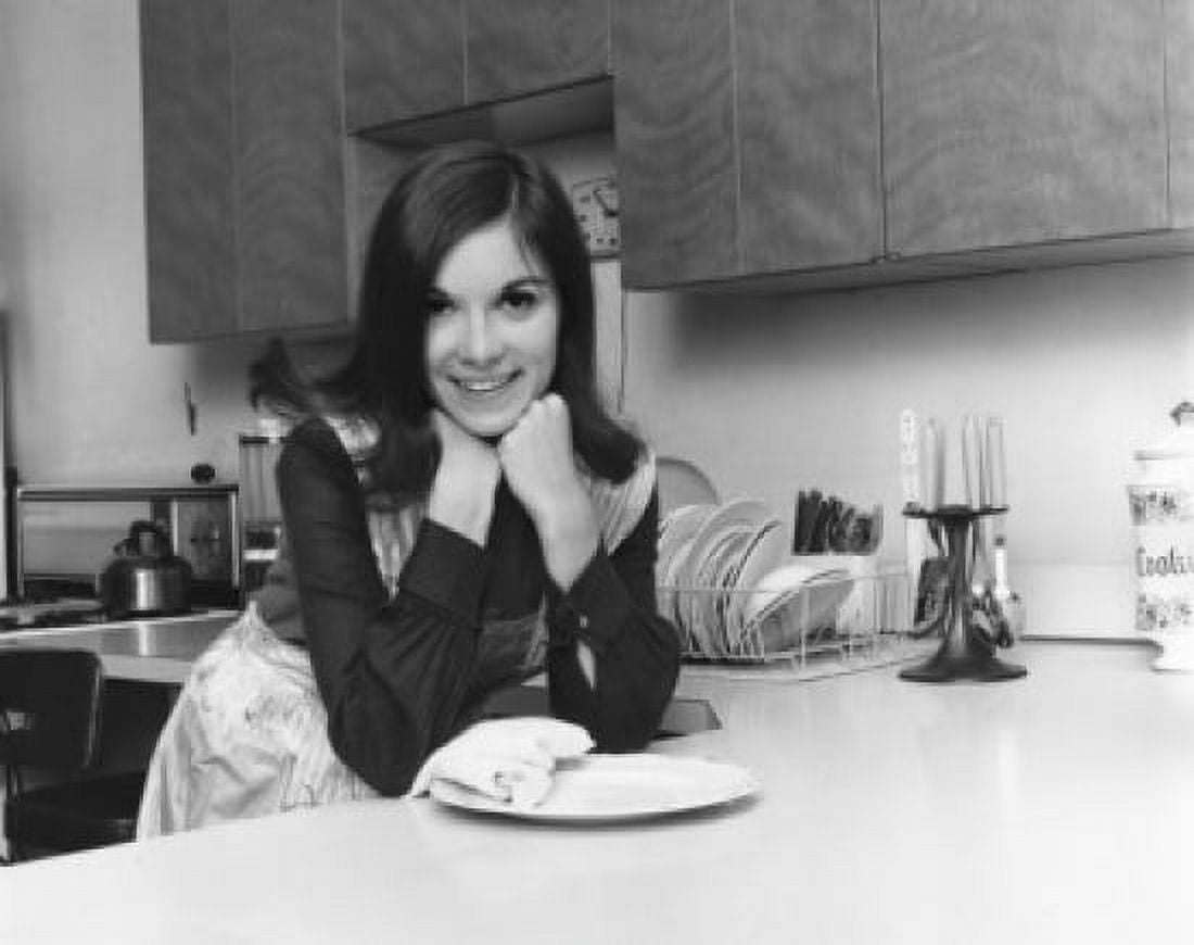 Portrait of a young woman leaning against a kitchen counter Canvas Art - (24 x 36)