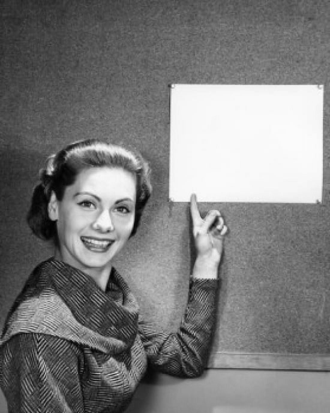 Portrait of a young woman pointing to a blank placard Canvas Art - (18 x 24)