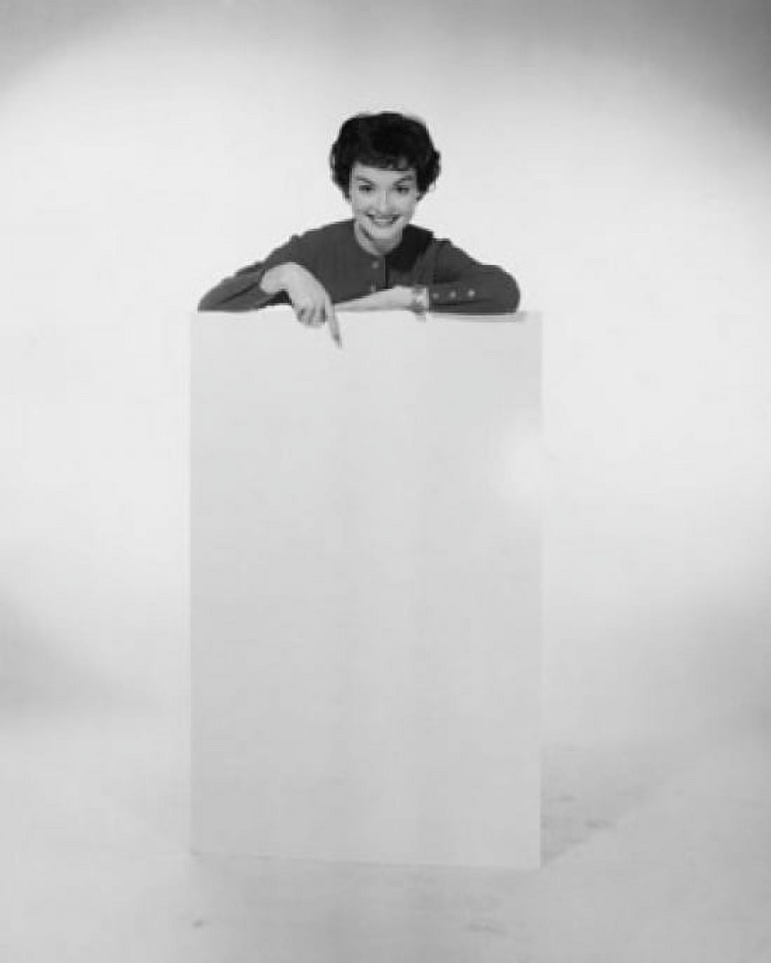 Portrait of a young woman pointing to a blank placard Canvas Art -  (18 x 24)