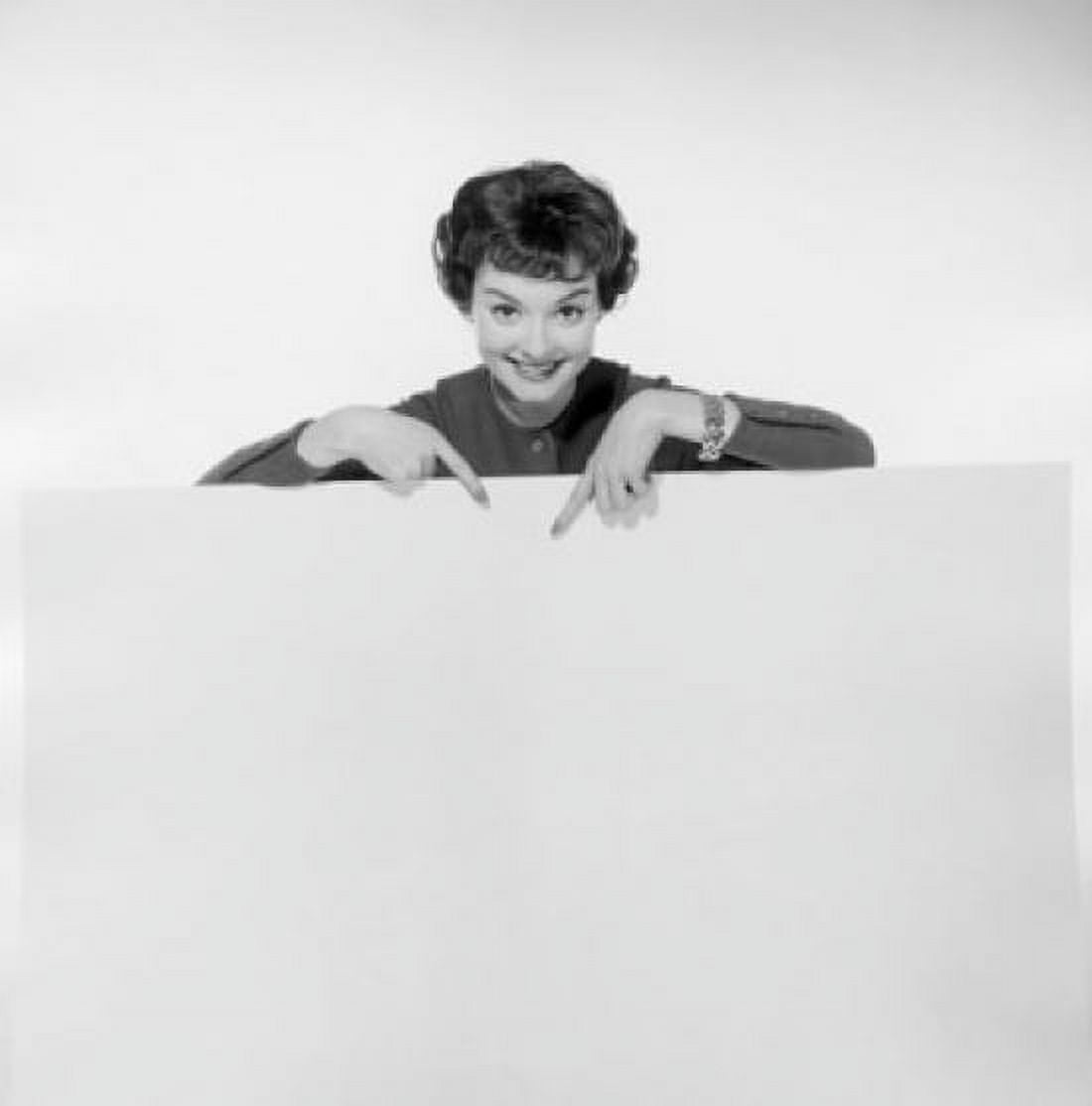 Portrait of a young woman pointing to a blank placard Canvas Art -  (18 x 24)