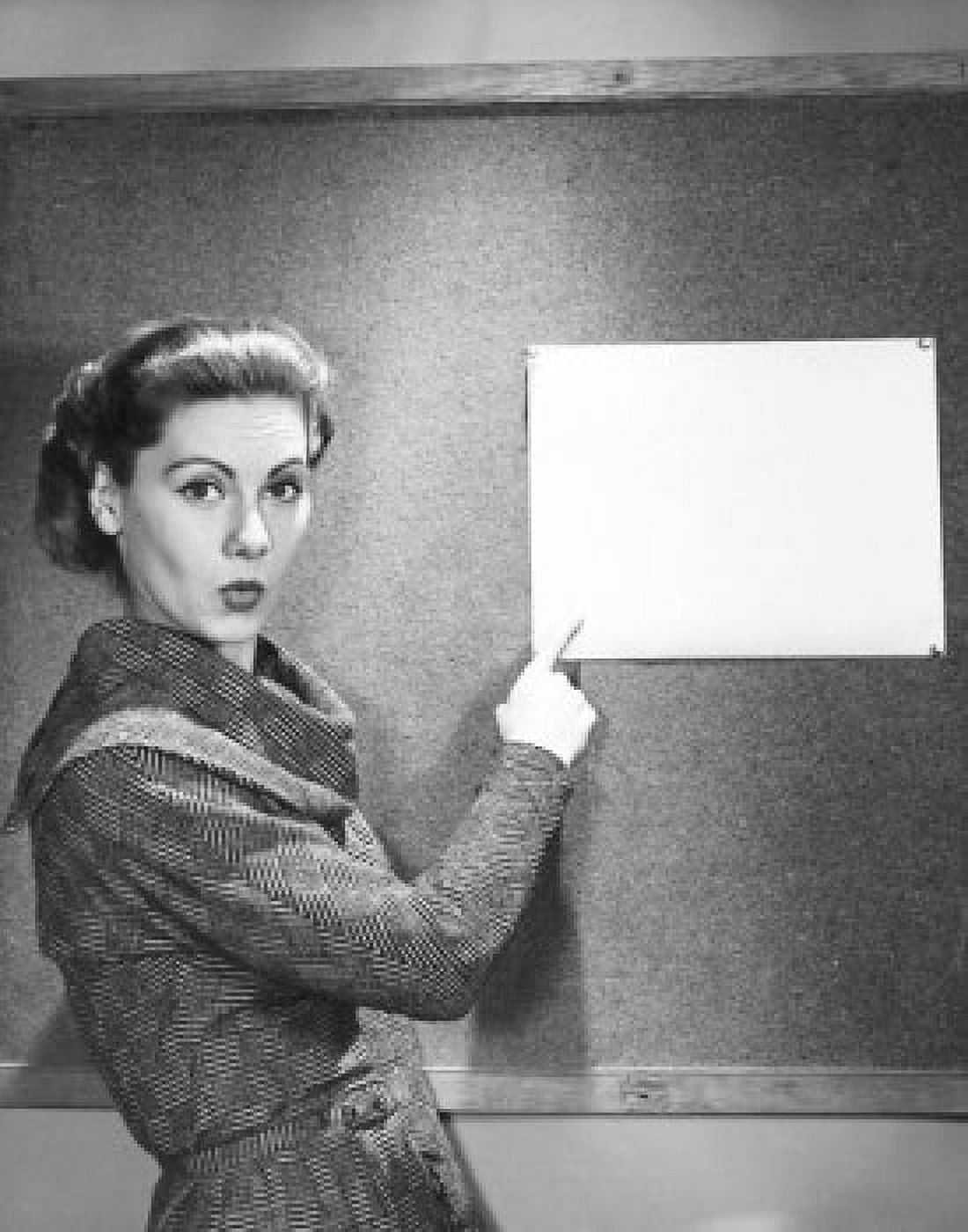 Portrait of a young woman pointing towards a paper Canvas Art - (18 x 24)