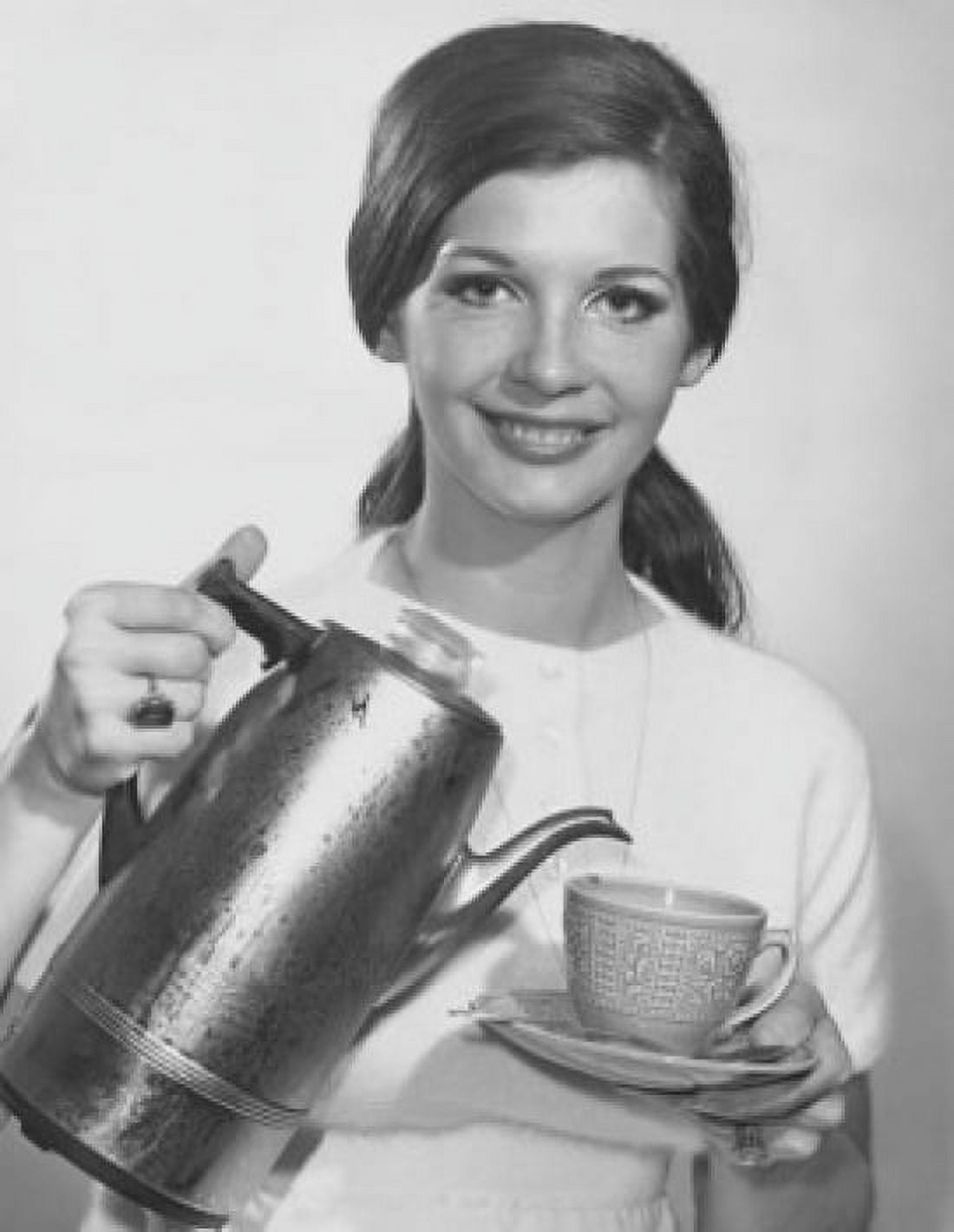Portrait of a young woman pouring tea from a kettle Canvas Art - (24 x 36)