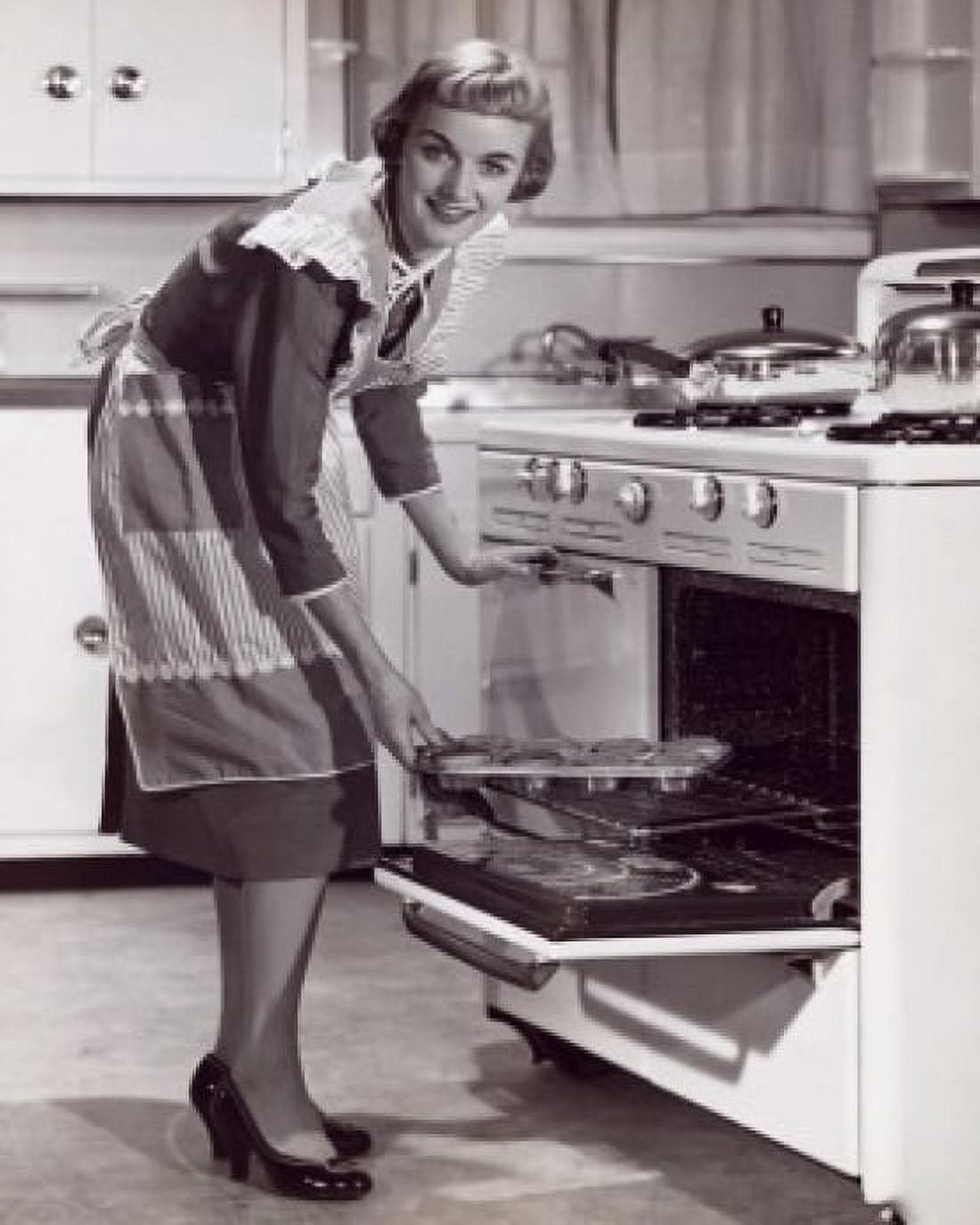 Portrait of a young woman putting food into an oven Canvas Art - (18 x 24)