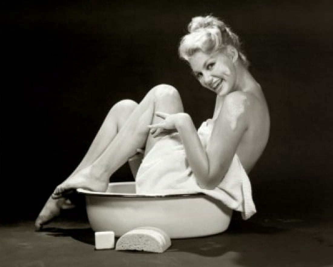 Portrait of a young woman sitting in a bathtub laughing Canvas Art - (18 x 24)