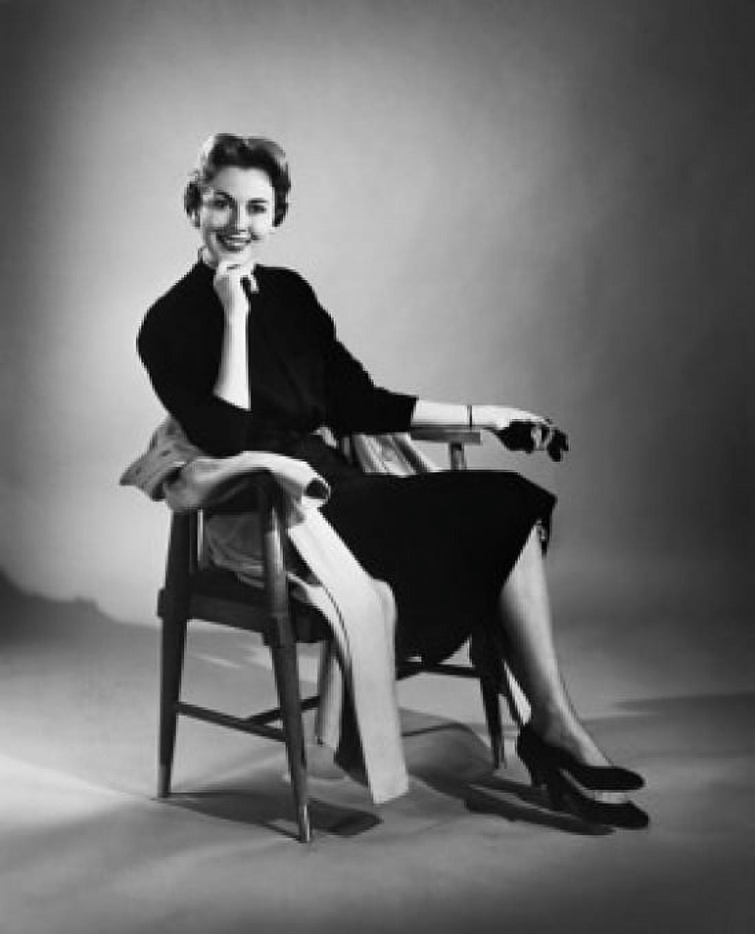 Portrait of a young woman sitting in a chair smiling Canvas Art - (24 x 36)