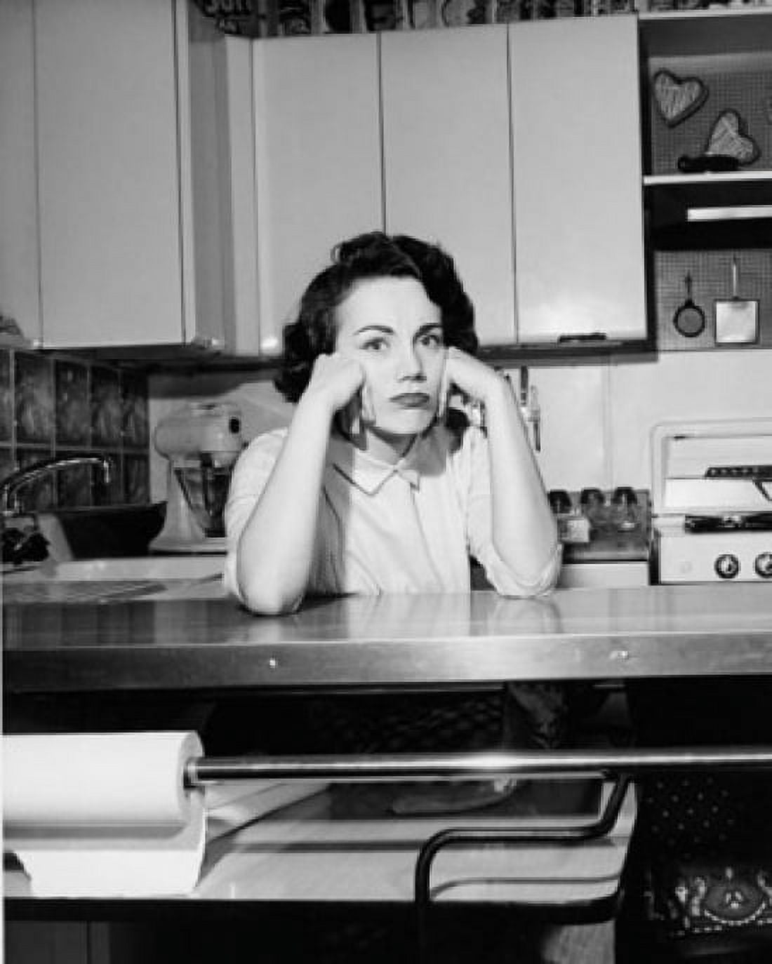 Portrait of a young woman sitting in the kitchen thinking Canvas Art - (24 x 36)