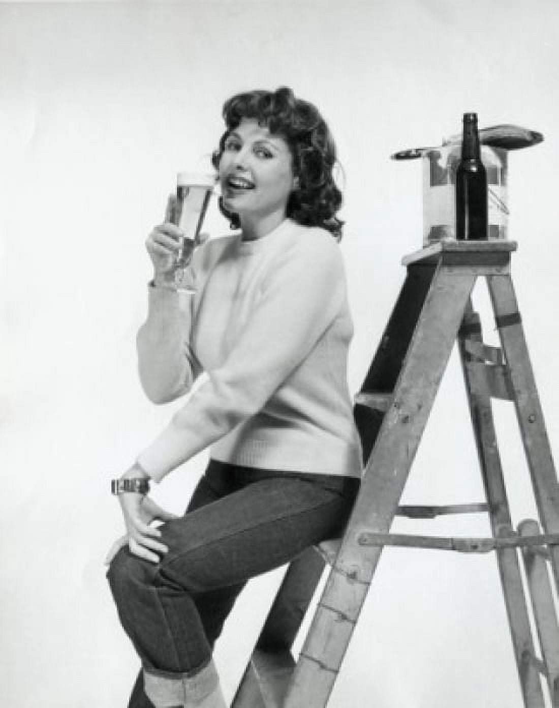 Portrait of a young woman sitting on a step ladder and drinking beer Canvas Art - (18 x 24)