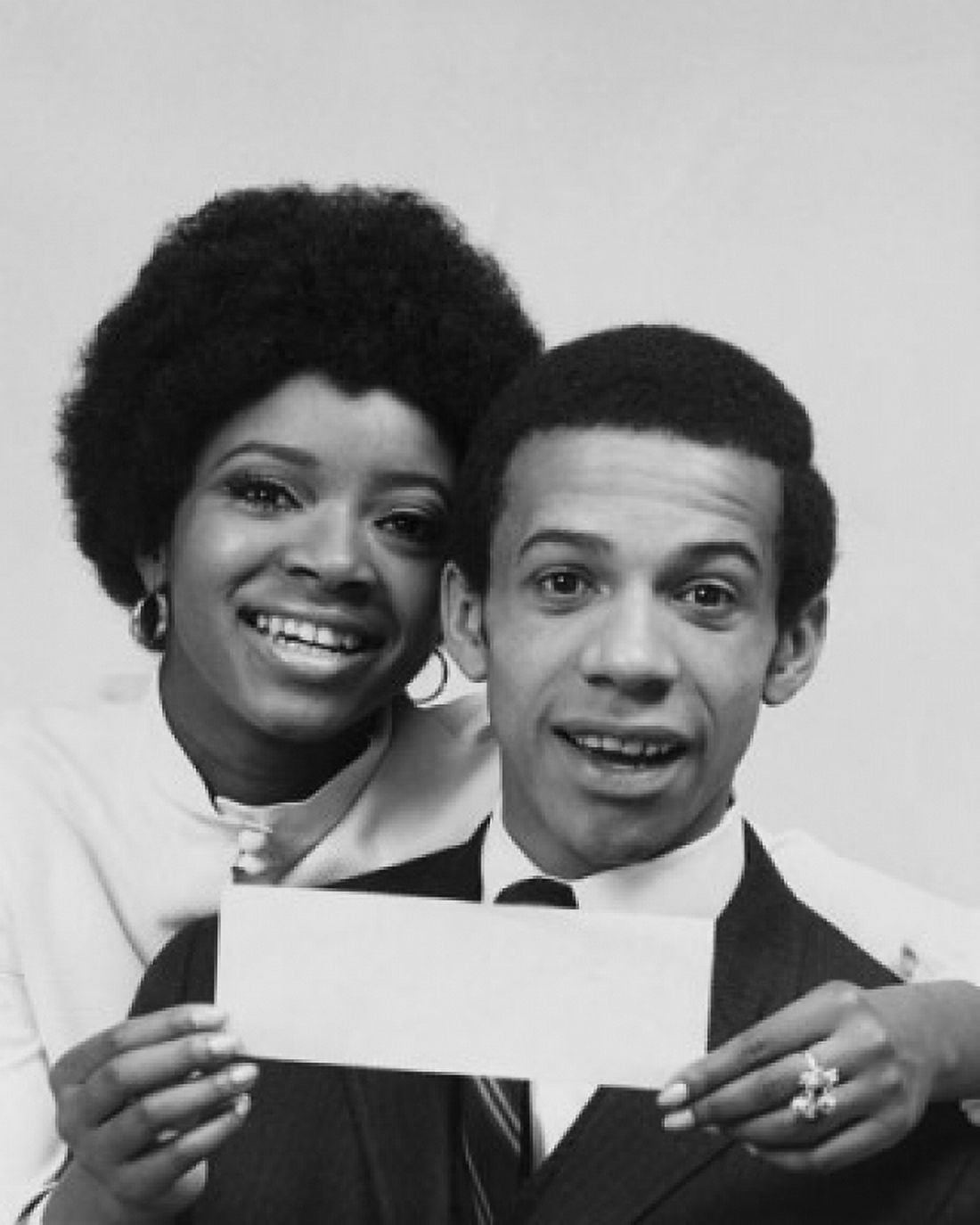 Portrait of a young woman smiling with a young man and holding a check Canvas Art - (18 x 24)