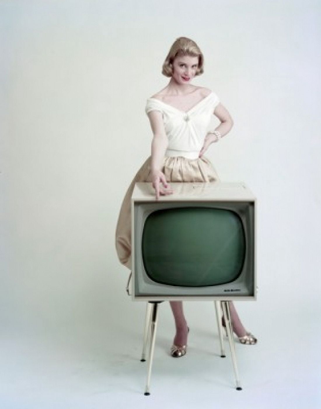 Portrait of a young woman standing behind a television and smiling Canvas Art - (24 x 36)