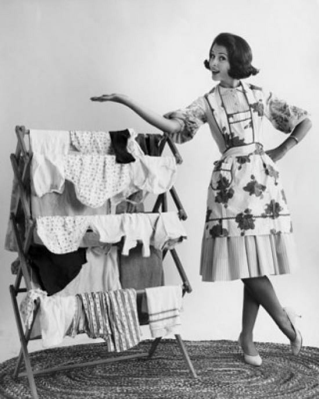 Portrait of a young woman standing near a drying rack Canvas Art - (18 x 24)