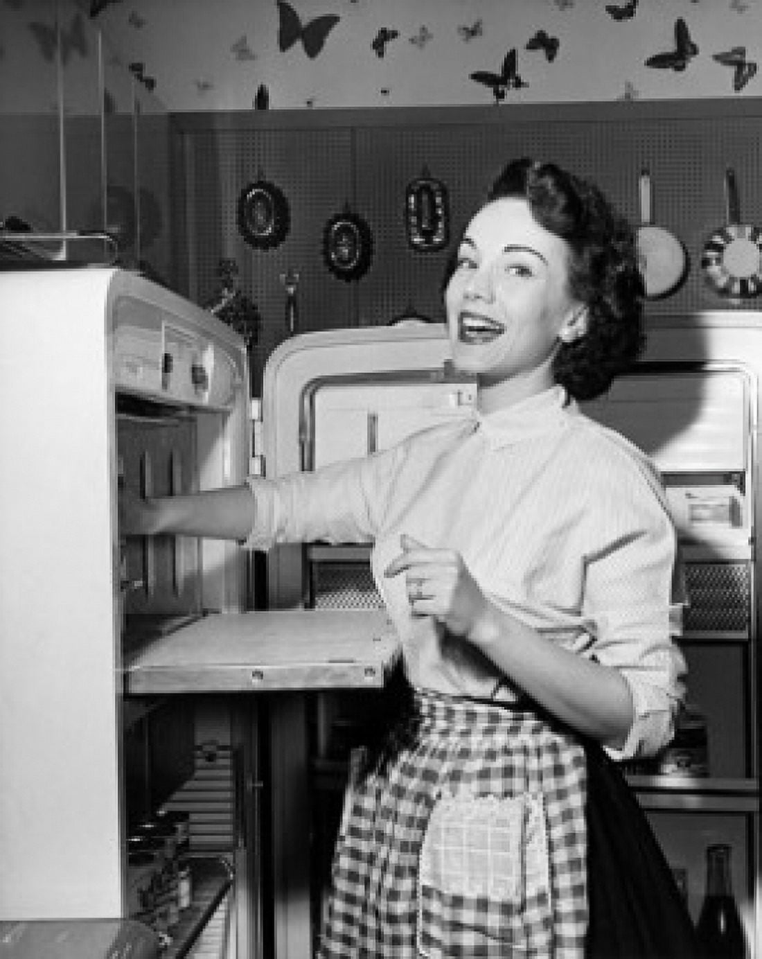 Portrait of a young woman standing near a refrigerator Canvas Art - (18 x 24)