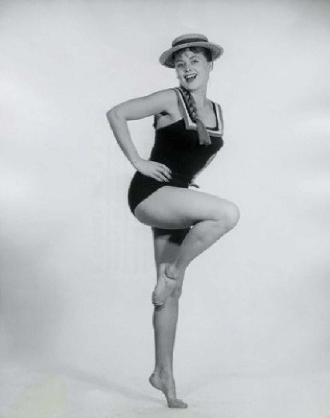 Portrait of a young woman standing on one leg and smiling Canvas Art - (18 x 24)
