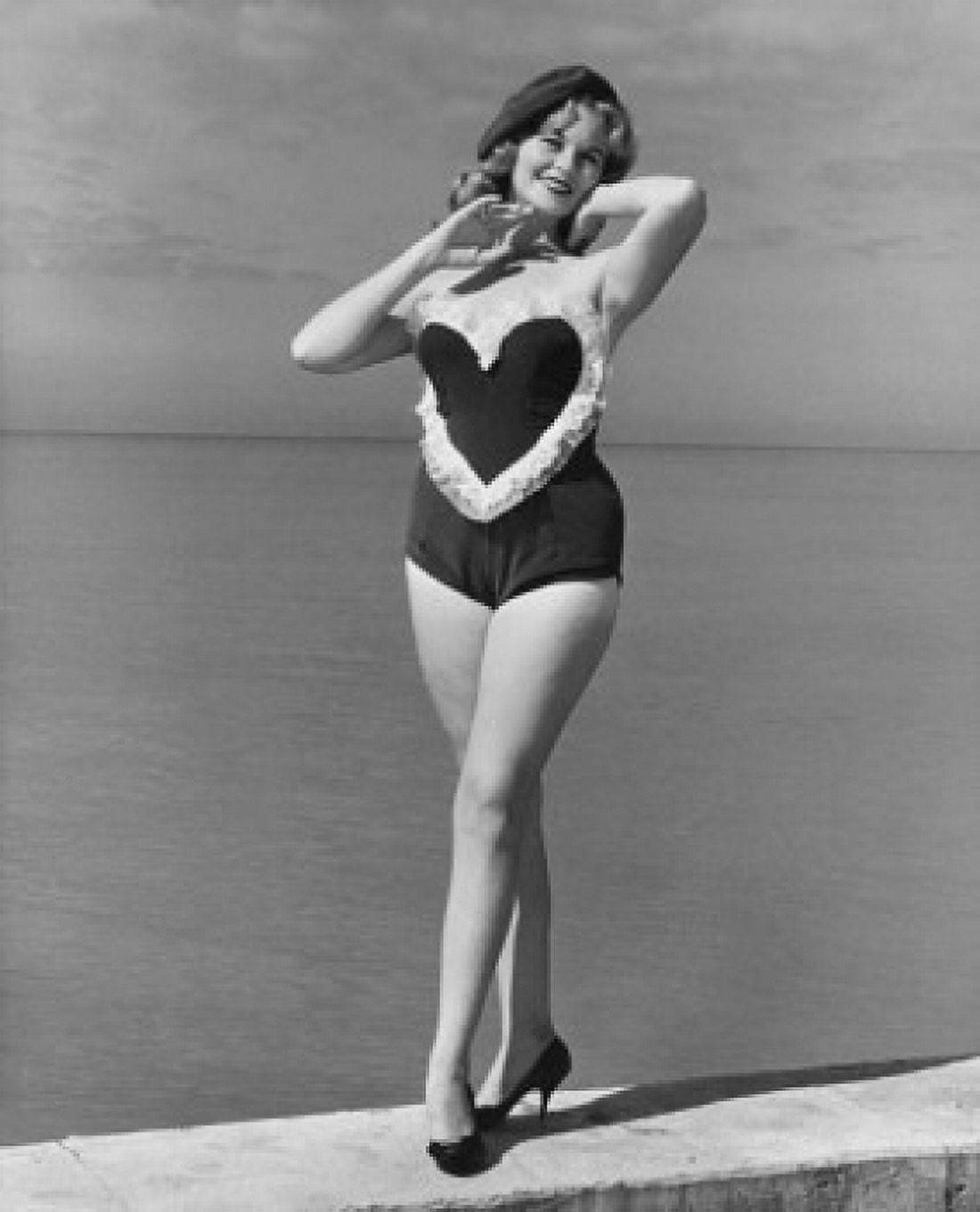 Portrait of a young woman standing on the beach smiling Canvas Art - (24 x 36)