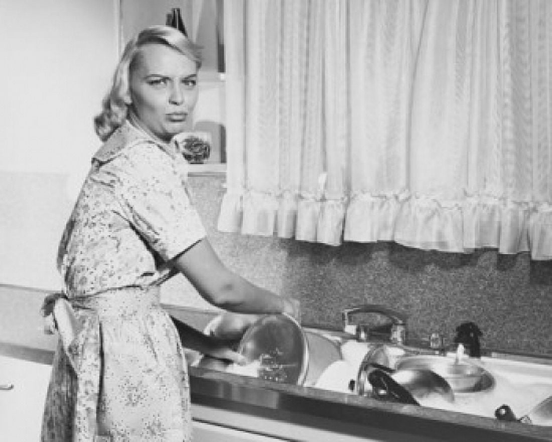 Portrait of a young woman washing pots and pans in a kitchen Canvas Art - (18 x 24)