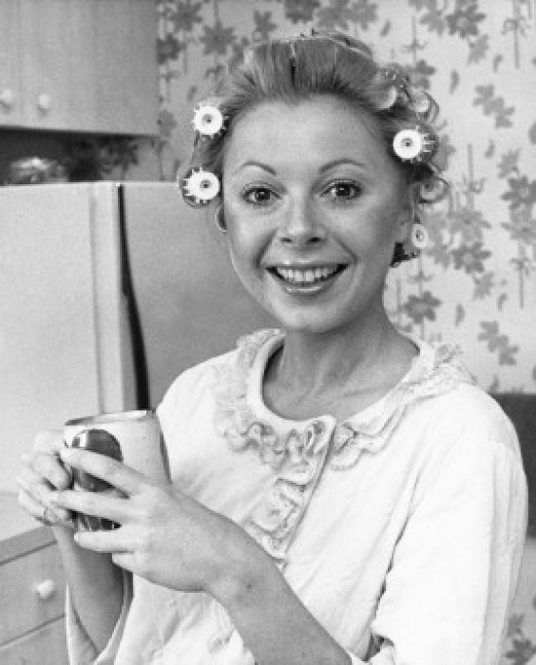 Portrait of a young woman with rollers holding a tea cup Canvas Art - (18 x 24)