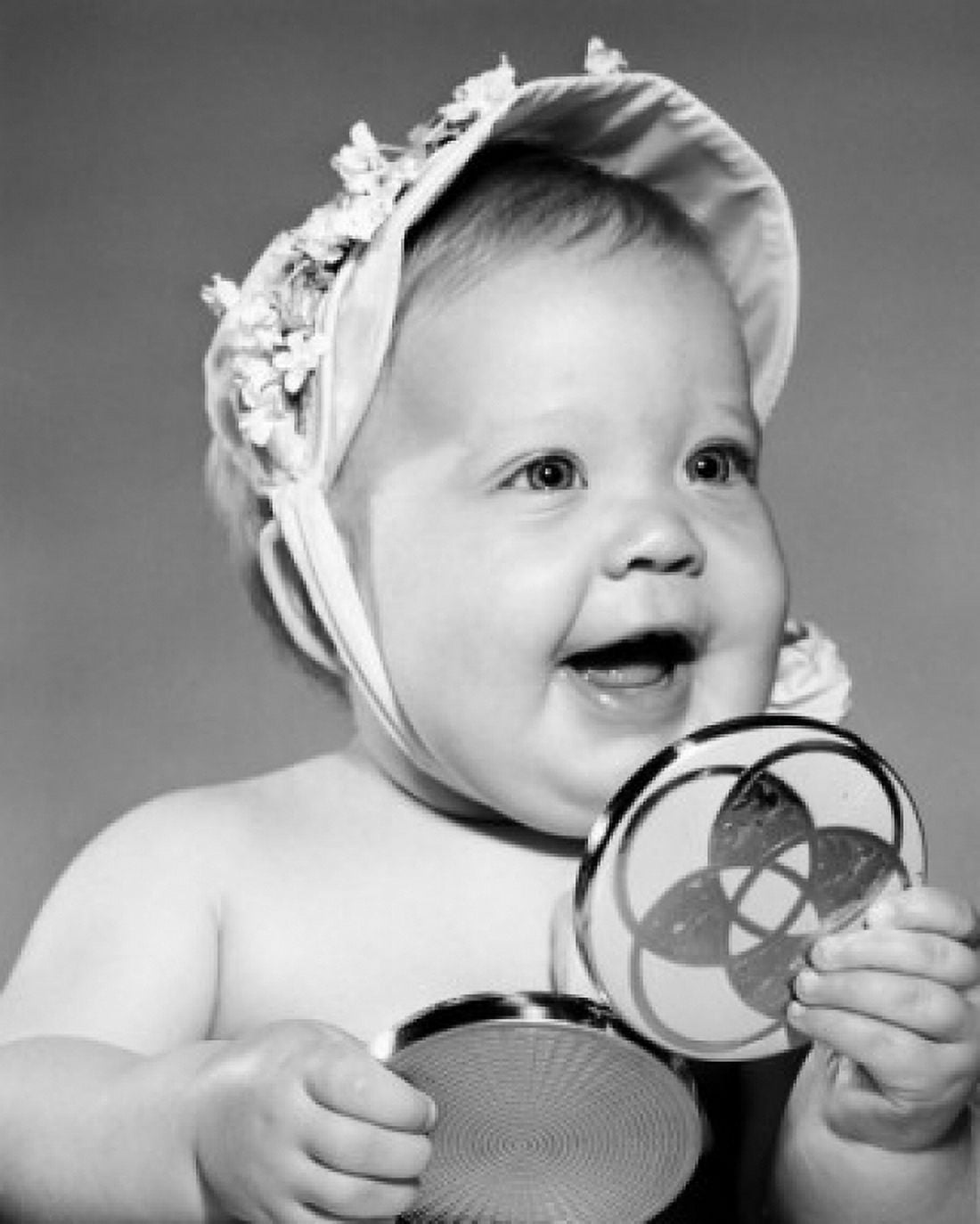 Portrait of baby girl holding hand mirror Canvas Art - (24 x 36)