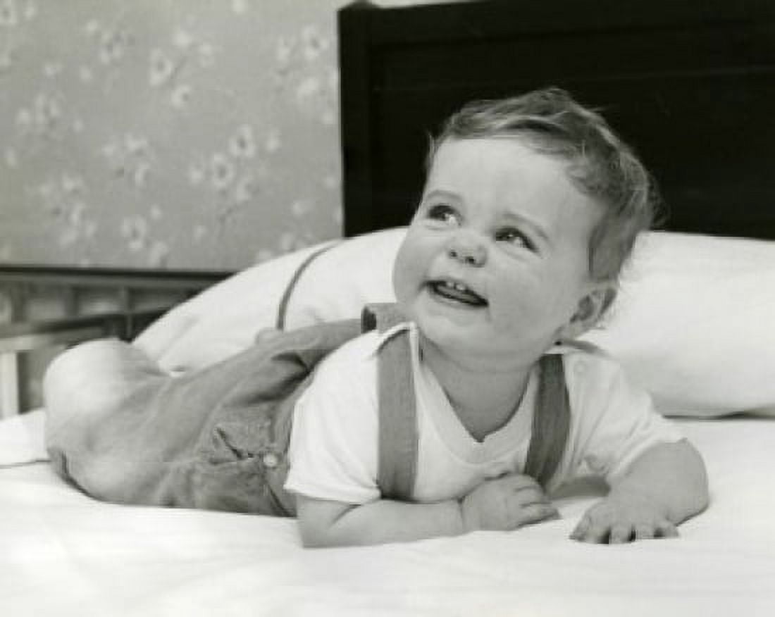 Portrait of baby lying on bed Canvas Art - (24 x 36)