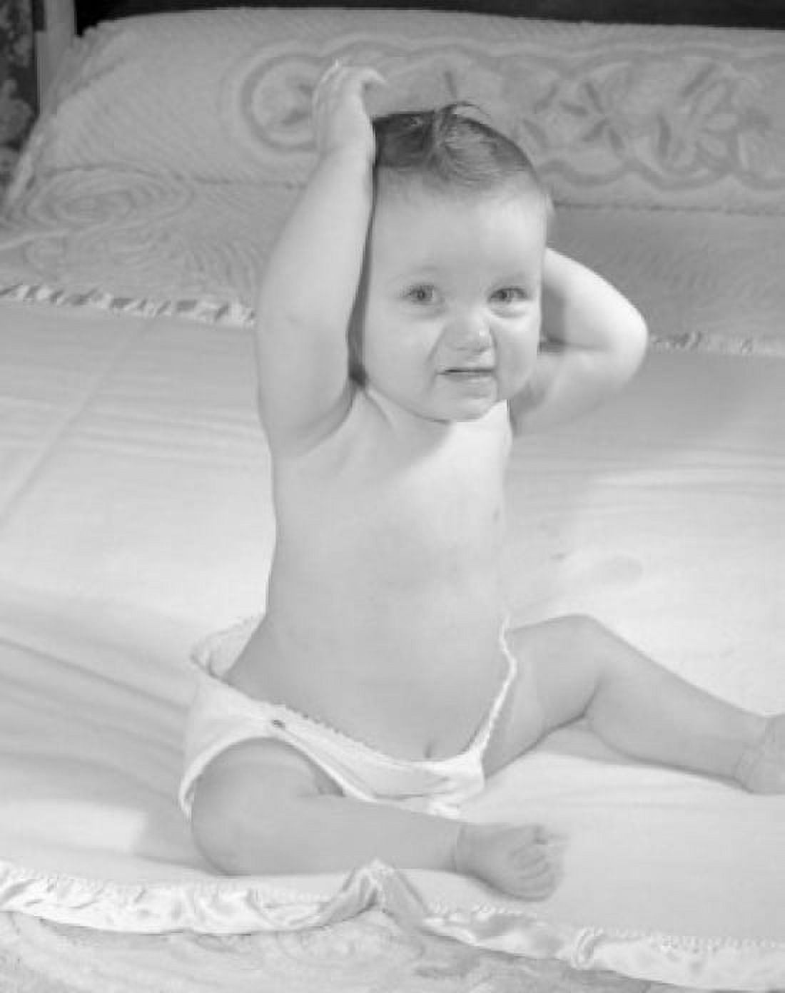 Portrait of baby sitting on bed Canvas Art - (18 x 24)