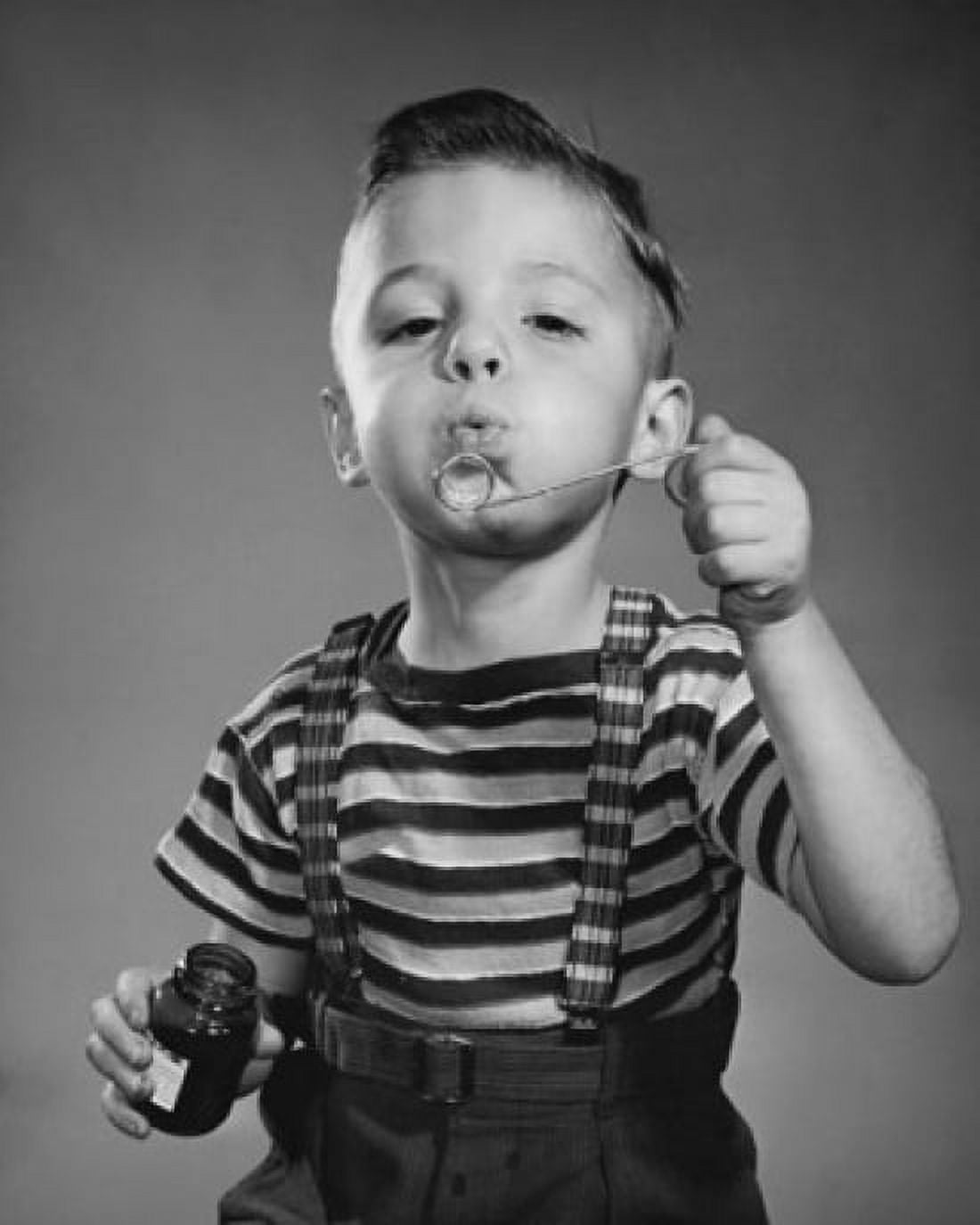 Portrait of boy blowing bubbles with bubble wand Canvas Art - (24 x 36)