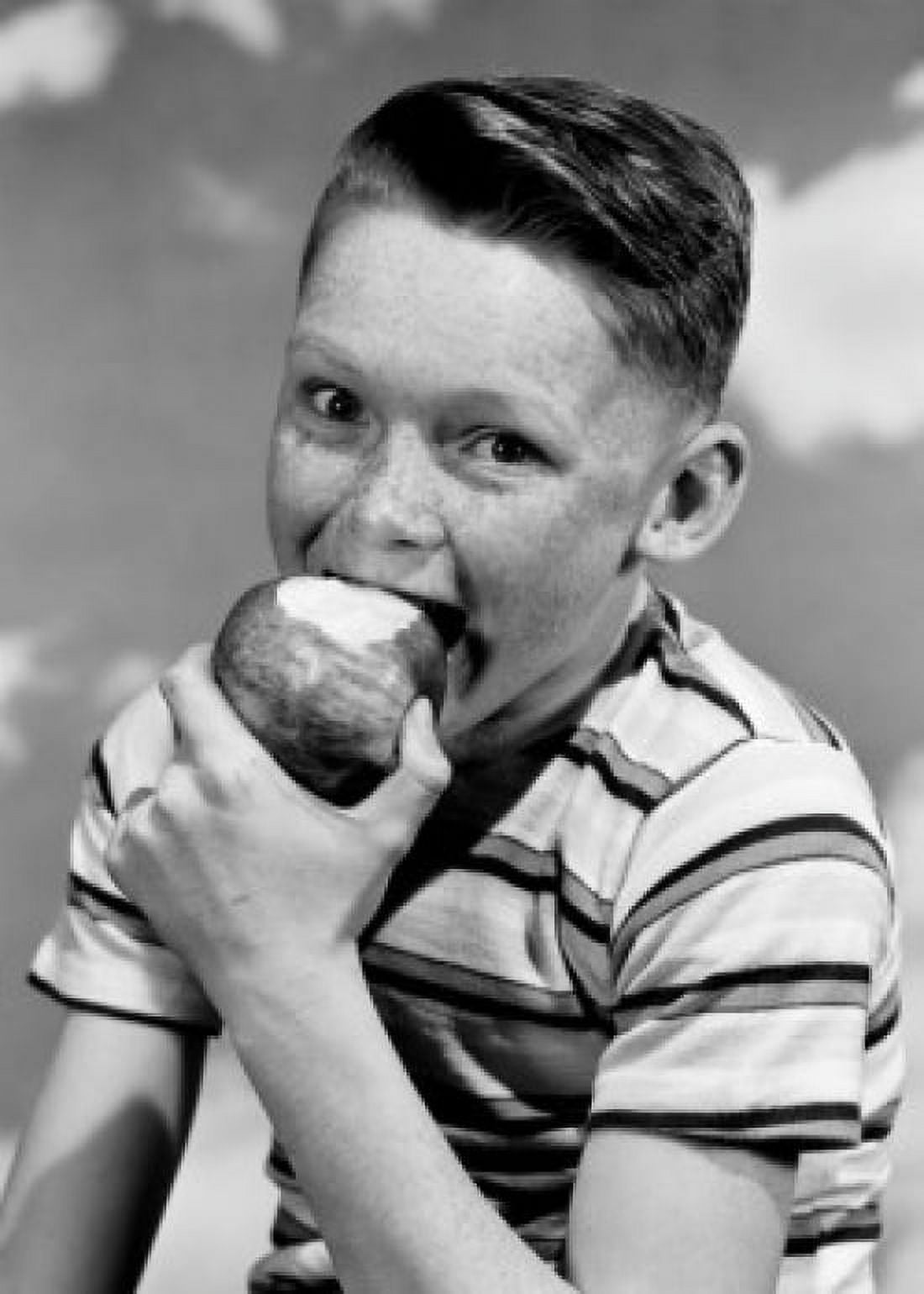Portrait of boy eating apple Canvas Art - (24 x 36)