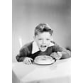 thumbnail image 1 of Portrait of boy eating breakfast cereal at table Poster Print (18 x 24), 1 of 4