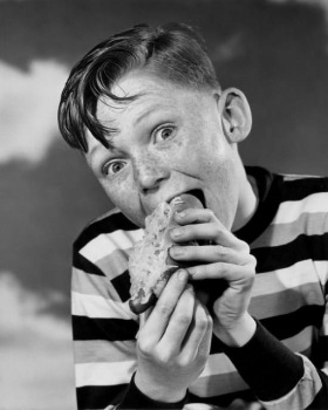 Portrait of boy eating hot dog Canvas Art - (18 x 24)
