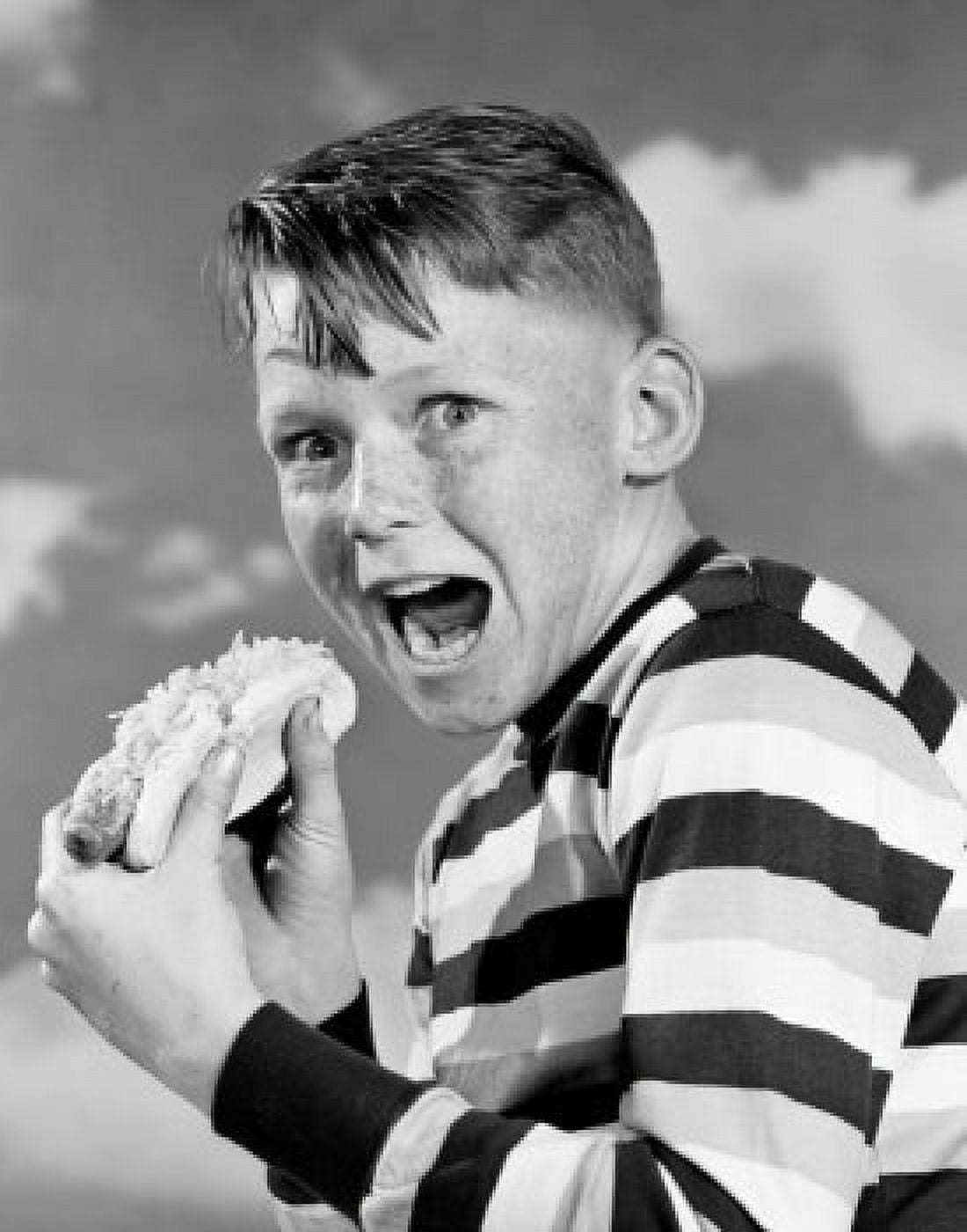 Portrait of boy eating hot dog Canvas Art - (24 x 36)