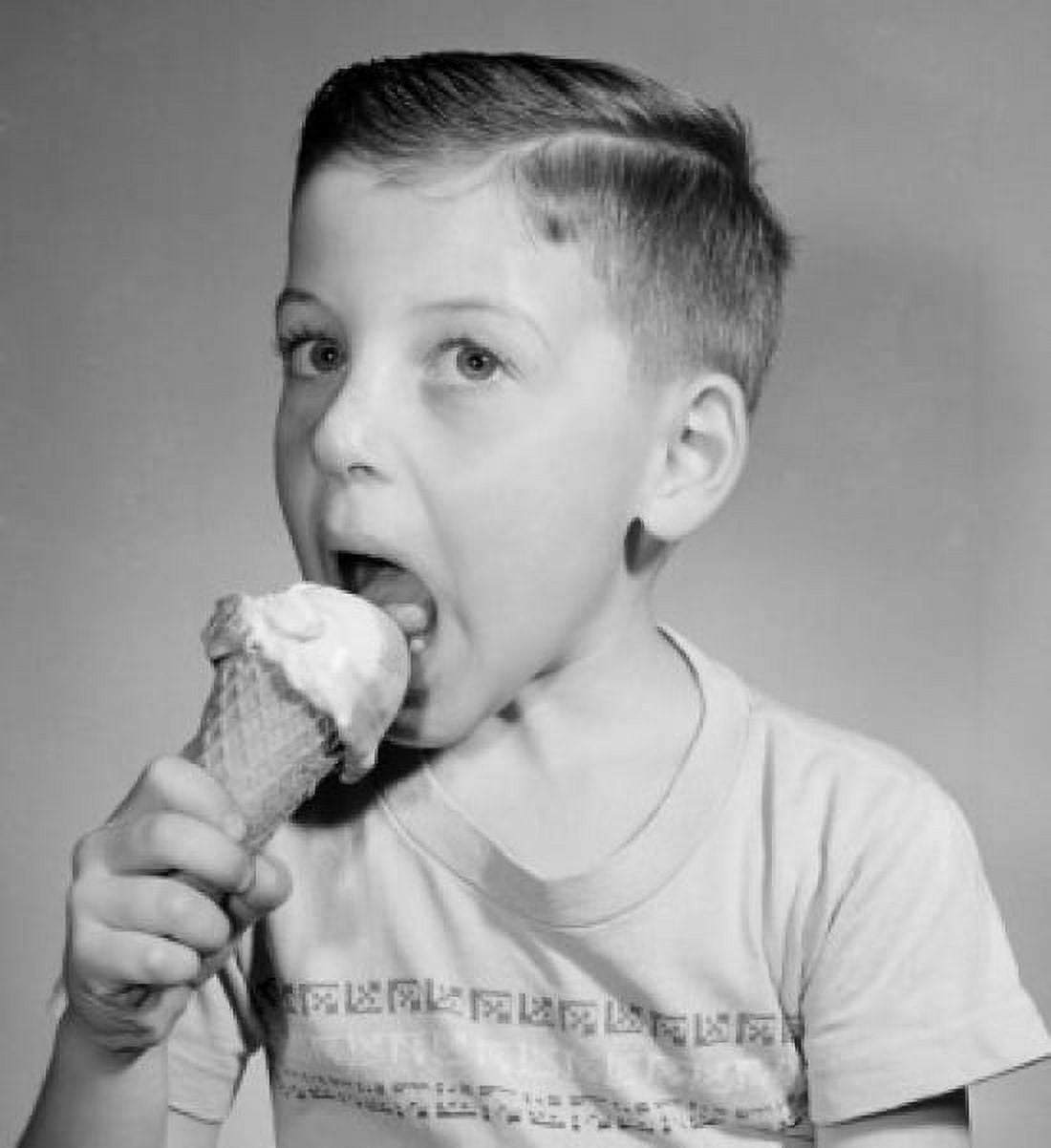 Portrait of boy eating icecream studio shot Canvas Art - (18 x 24)