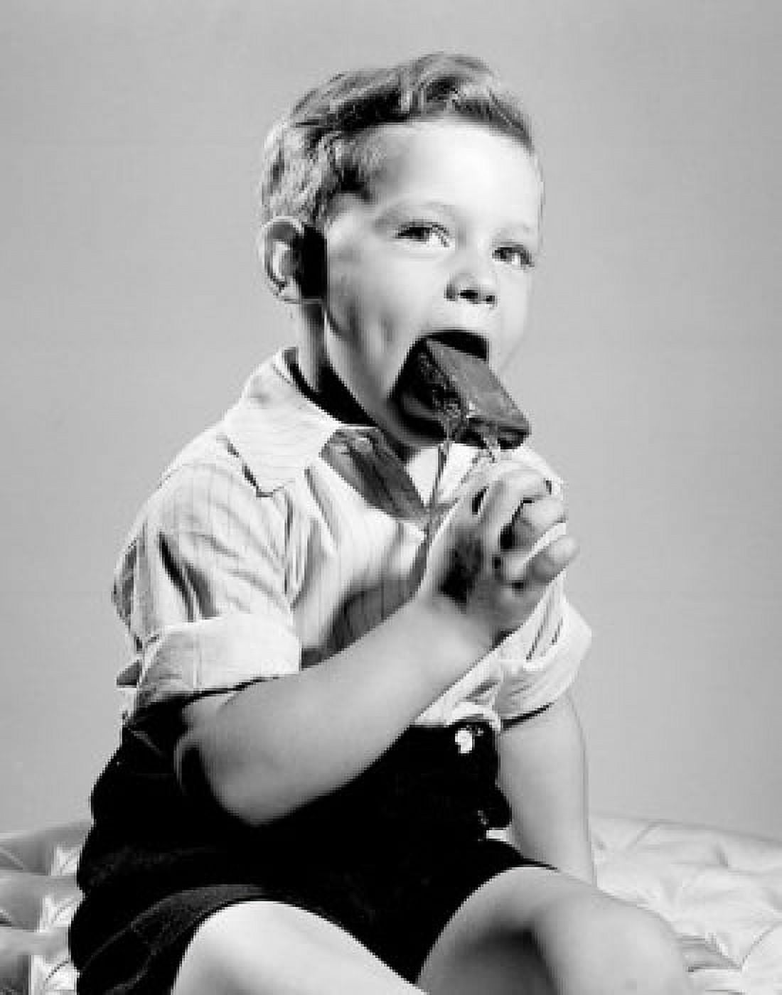 Portrait of boy eating popsicle Canvas Art - (24 x 36)