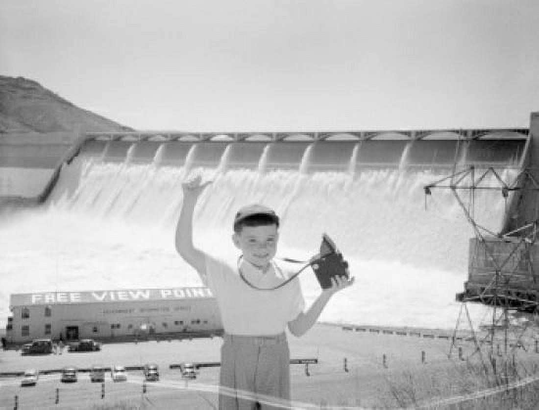 Portrait of boy holding camera dam in the background Canvas Art - (18 x 24)