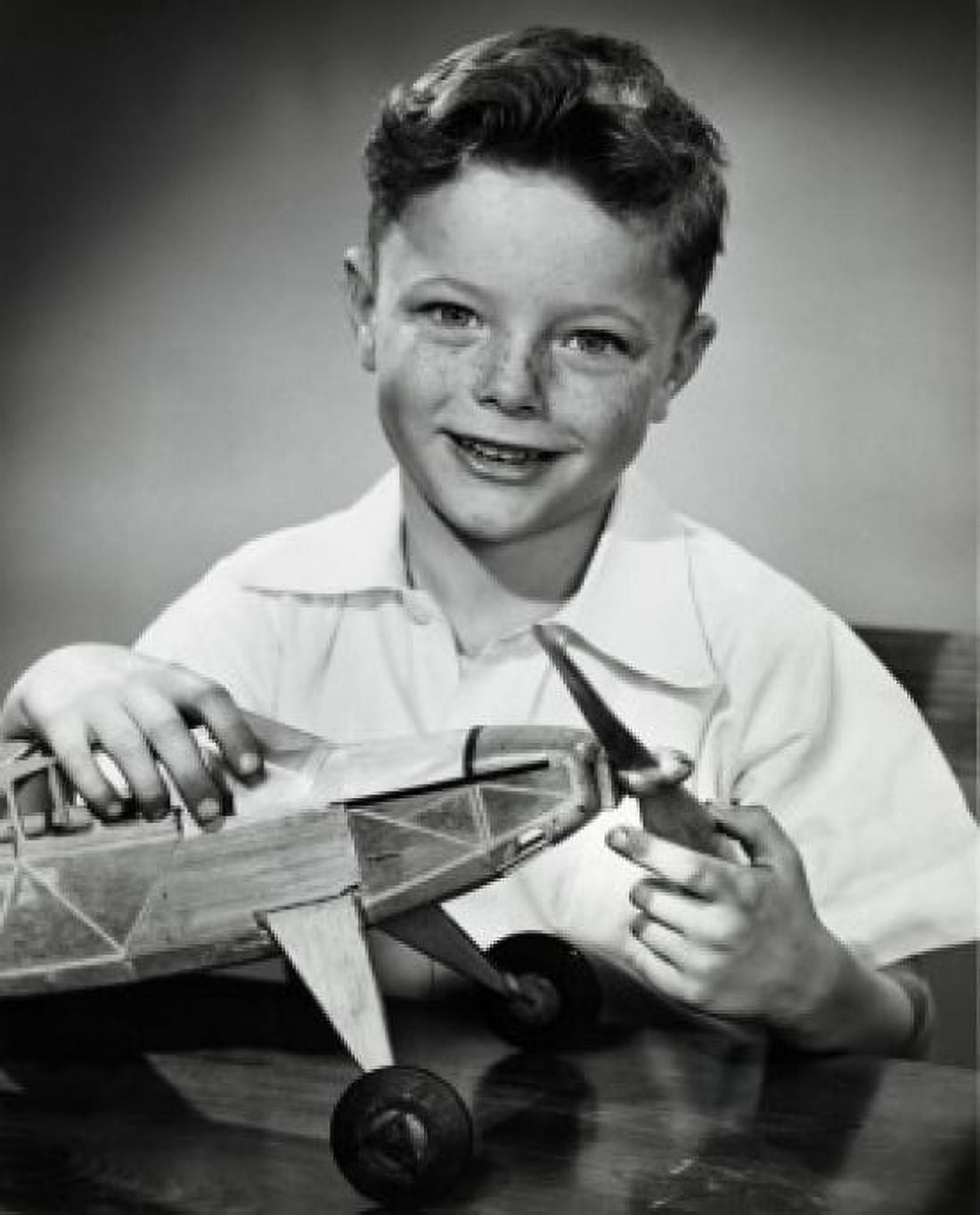 Portrait of boy holding model airplane Canvas Art - (18 x 24)
