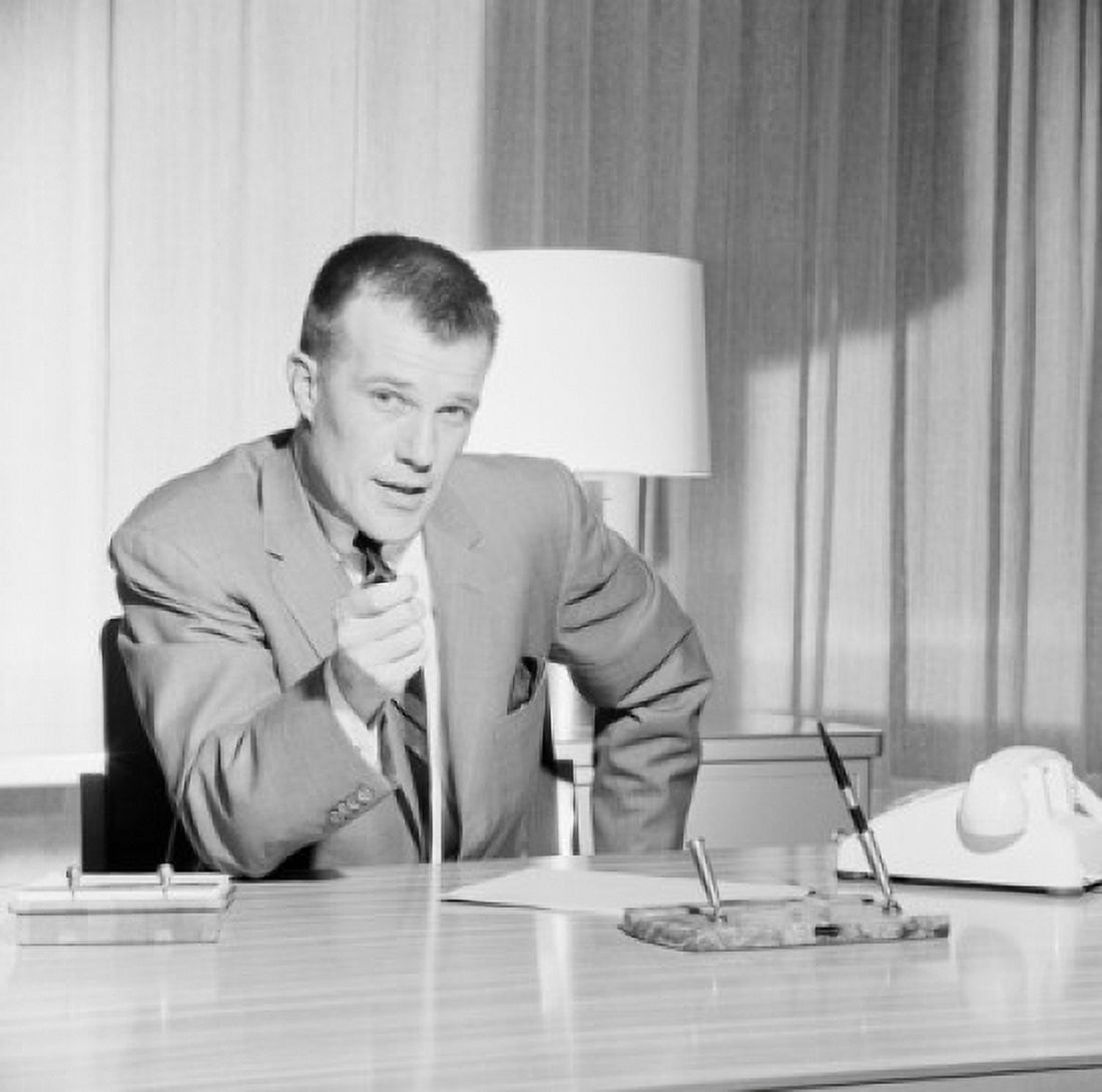 Portrait of businessman sitting behind desk in office Canvas Art - (18 x 24)