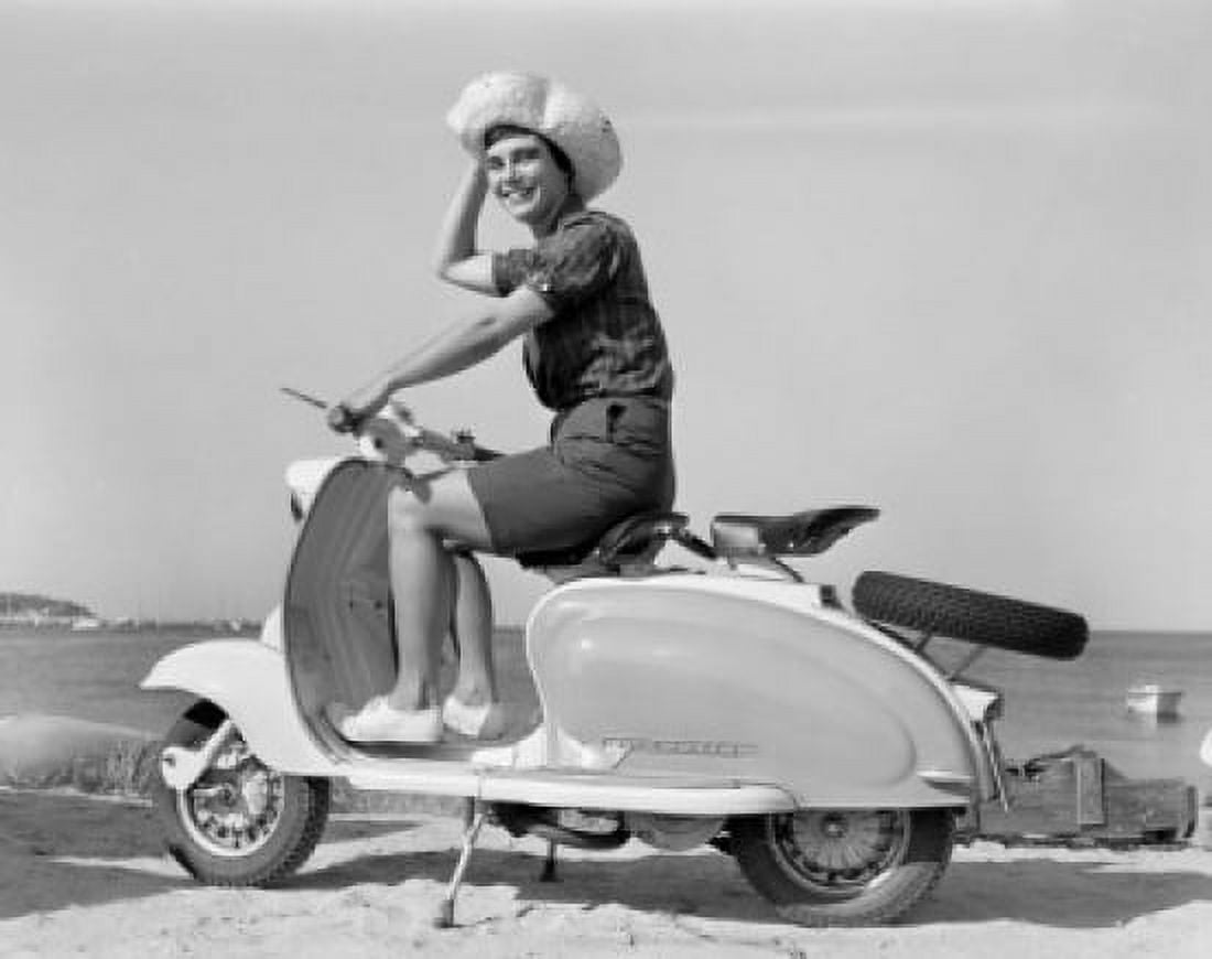Portrait of cheerful young woman sitting on scooter Canvas Art - (24 x 36)