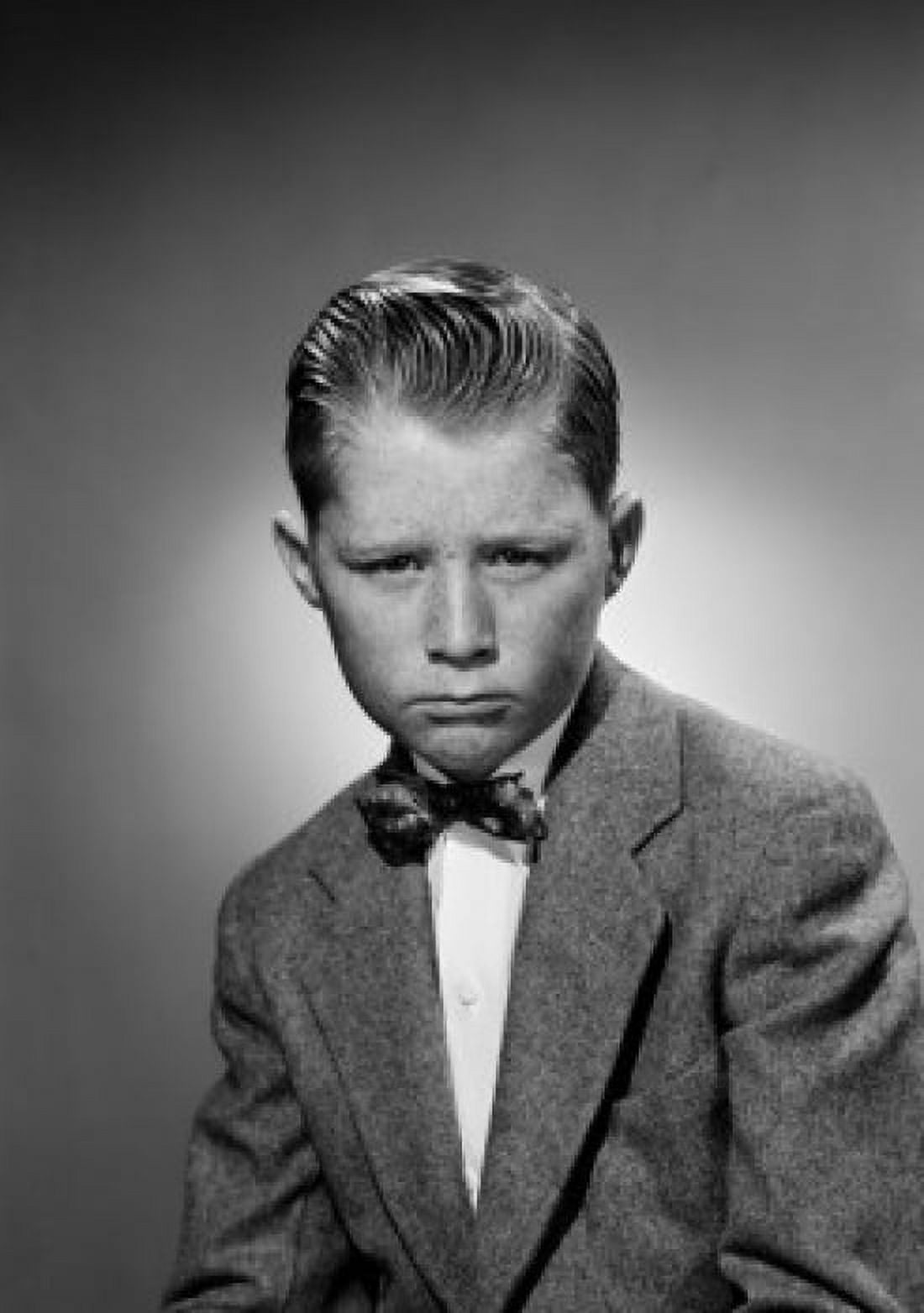 Portrait of displeased boy wearing suit and bow tie studio shot Canvas Art - (24 x 36)
