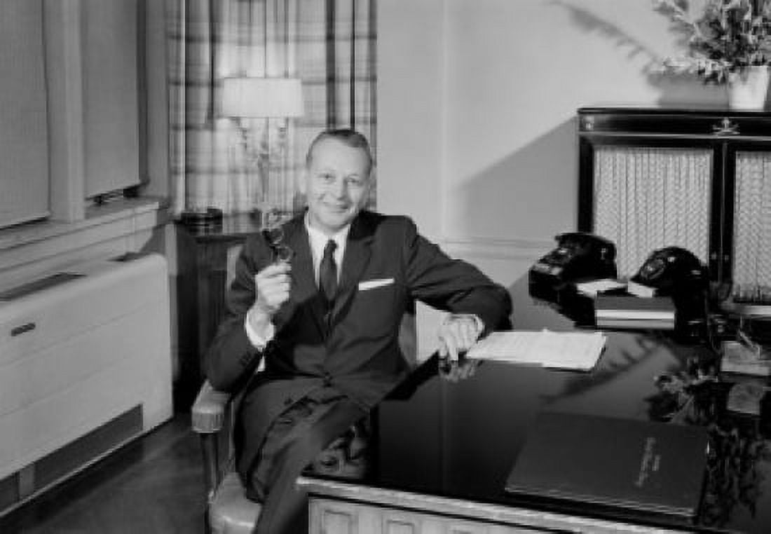 Portrait of elegant businessman sitting at desk Canvas Art - (24 x 36)