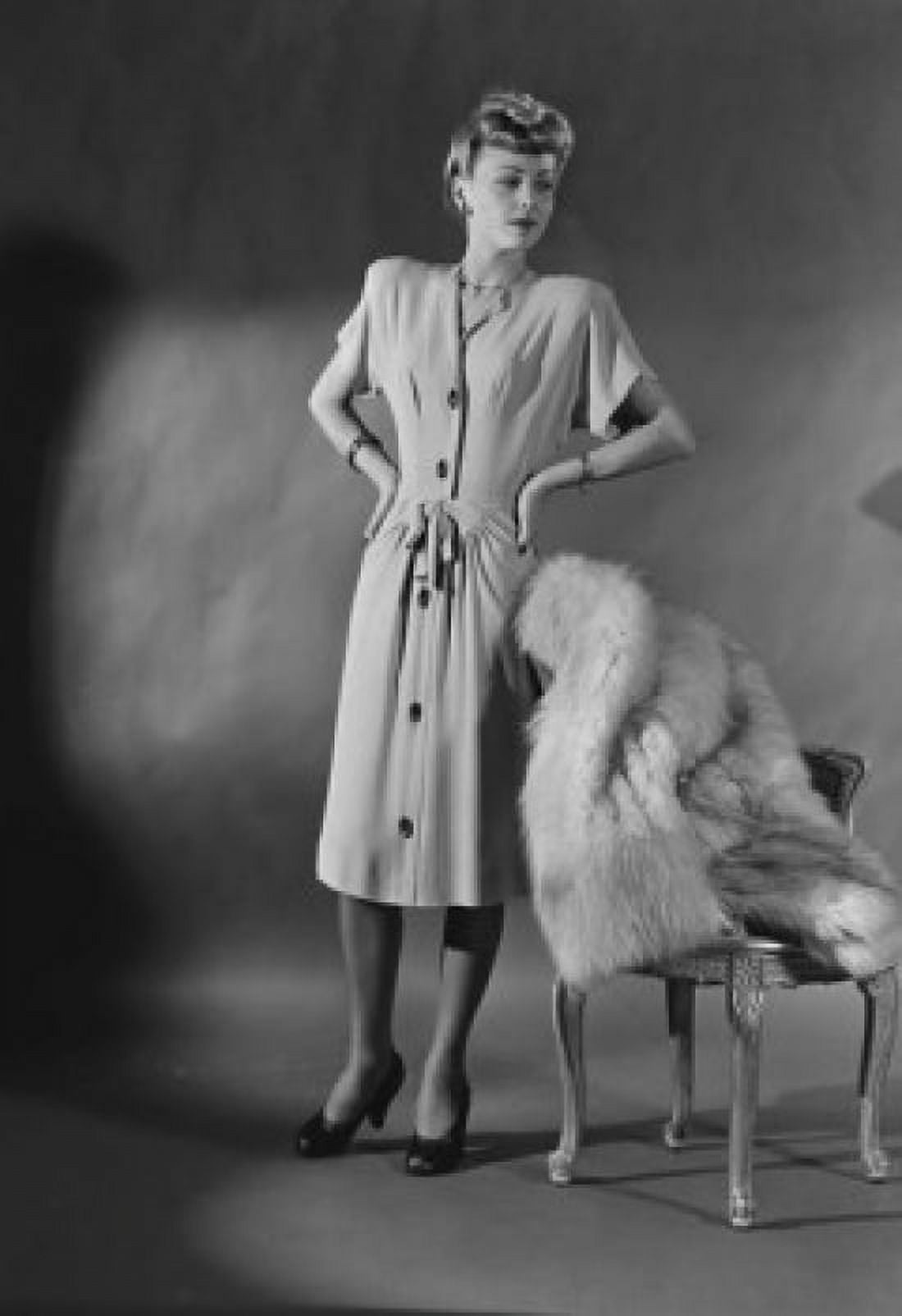 Portrait of elegant woman standing by chair covered with fur Canvas Art - (18 x 24)